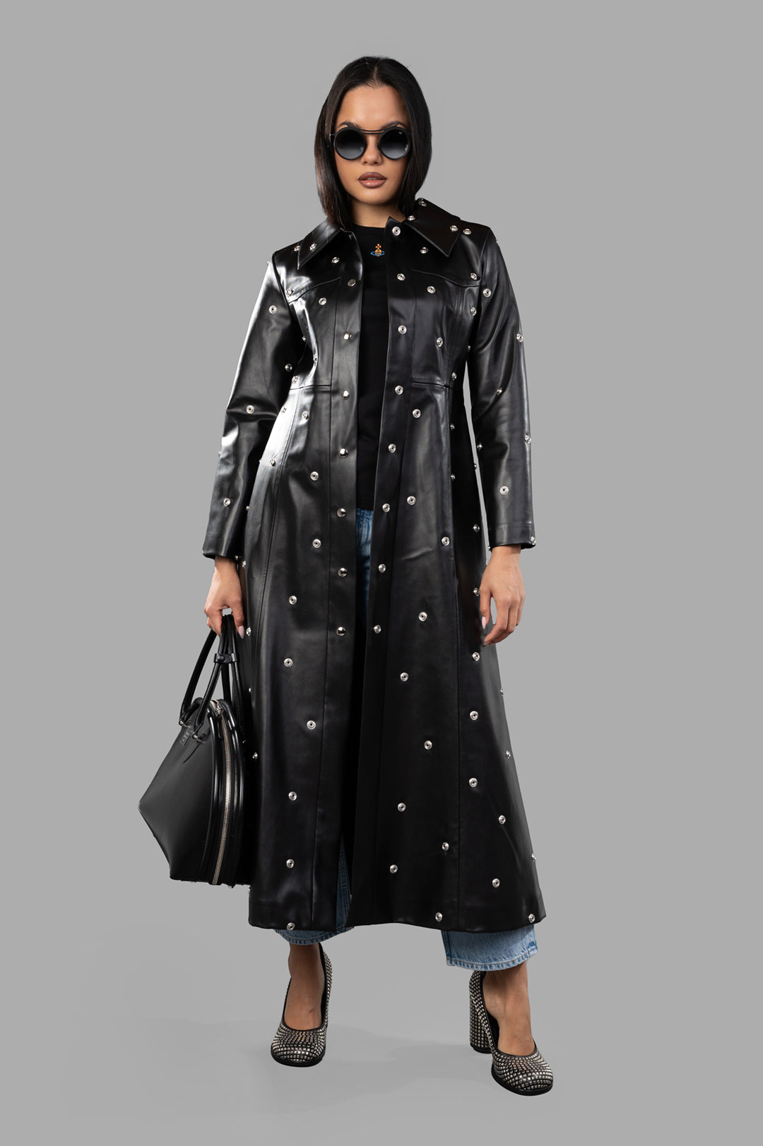 A.W.A.K.E. MODE Faux Leather Studded Coat in black, front view on model, showing fitted bodice and flared skirt design.