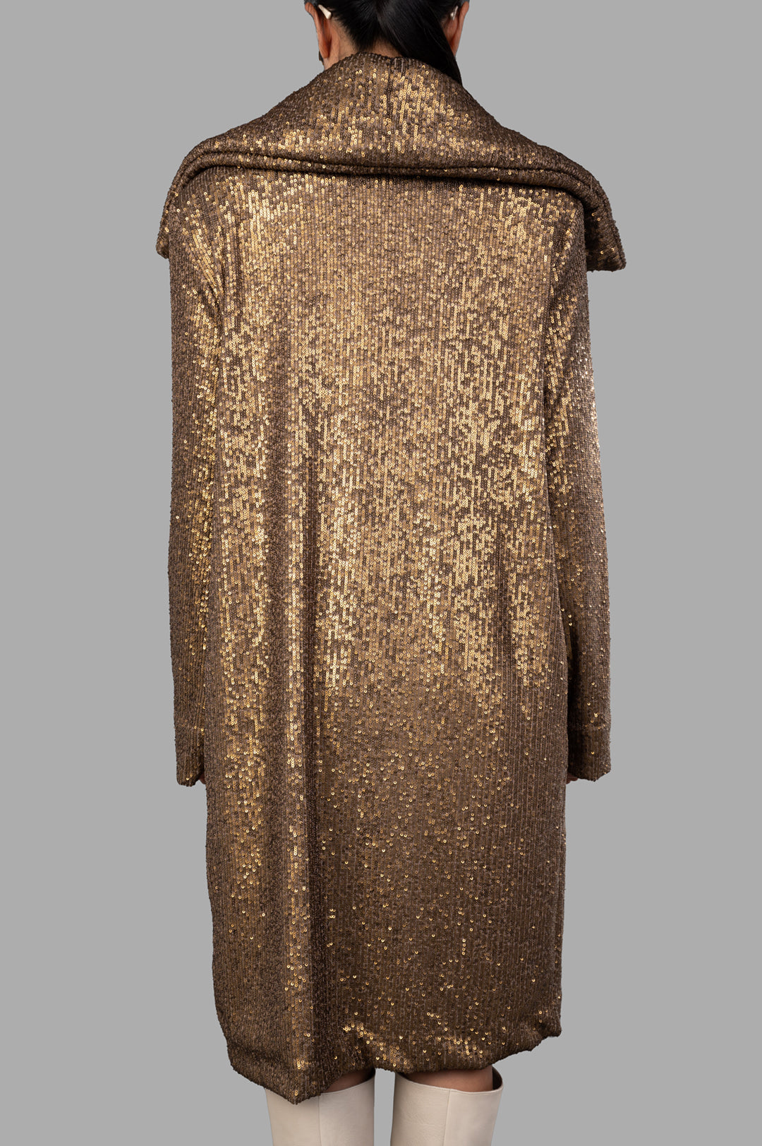 Norma Kamali Sequin Trench featuring a dazzling bronze sequin design, shown from the back with wide lapels and knee-length.