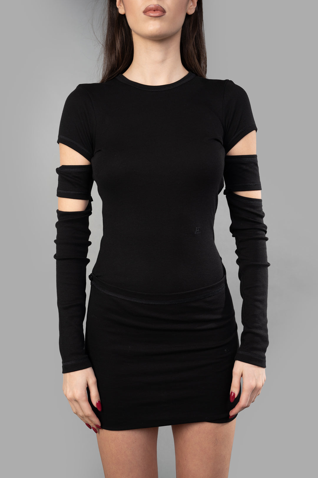 Helmut Lang Slash Mini Dress with cut-out detailing and detachable sleeves; model wears black cotton-modal blend.