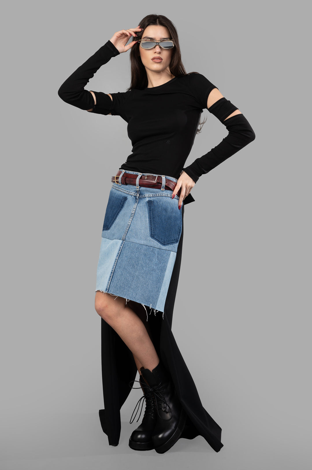 A.W.A.K.E. MODE Asymmetric Half-Denim Skirt, front view on-model, features unique denim patchwork and raw hem.