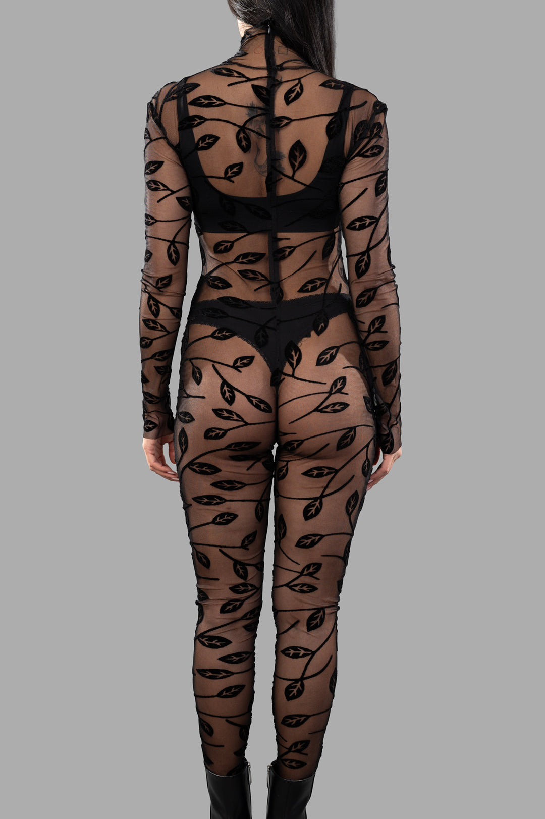 Norma Kamali Long-sleeved Lace Catsuit featuring a high-neck design and back zipper, showcasing a flattering silhouette.