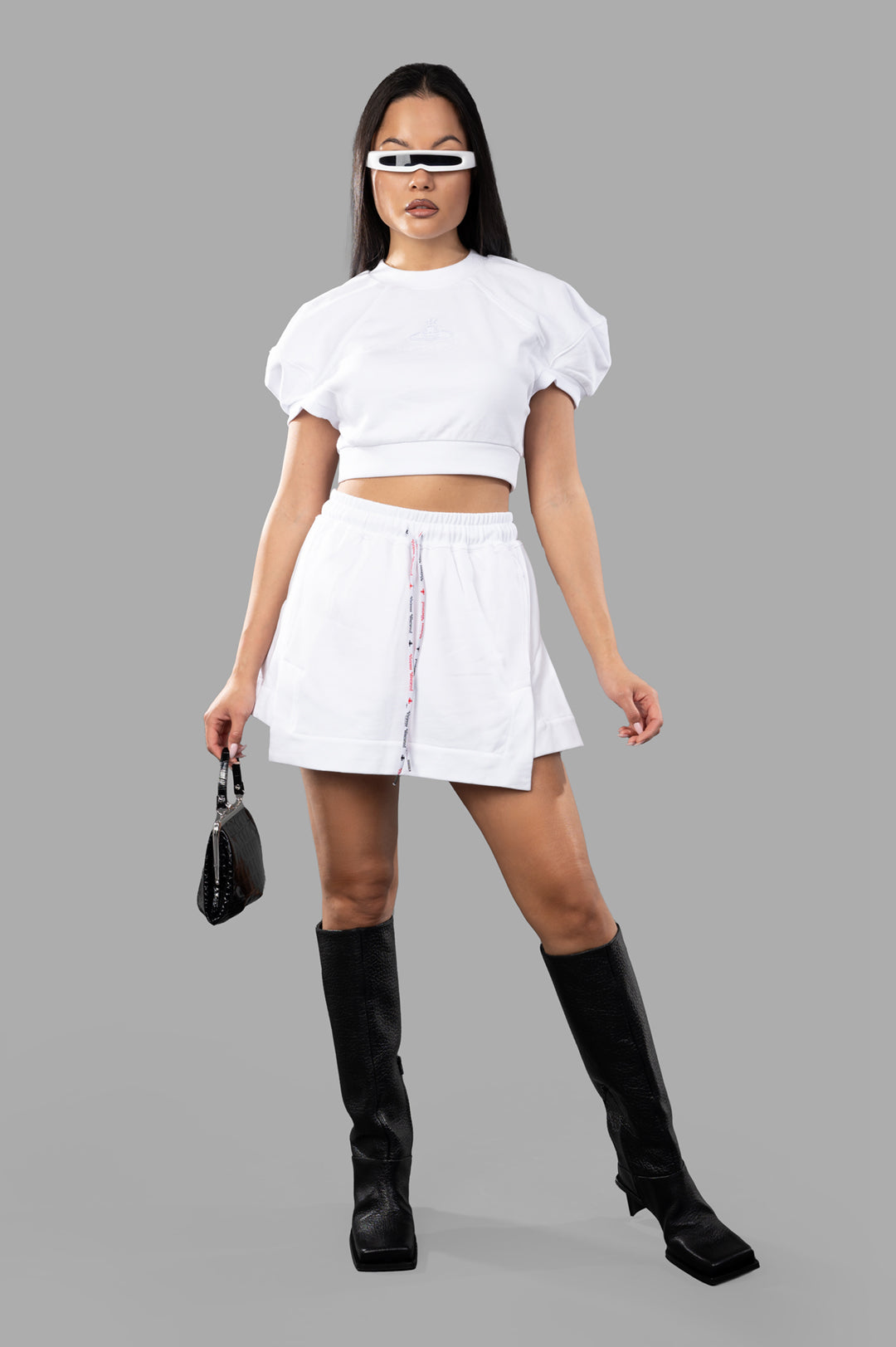 Vivienne Westwood Cheerleader Skirt in white, front view with A-line silhouette and adjustable tie, styled with boots.