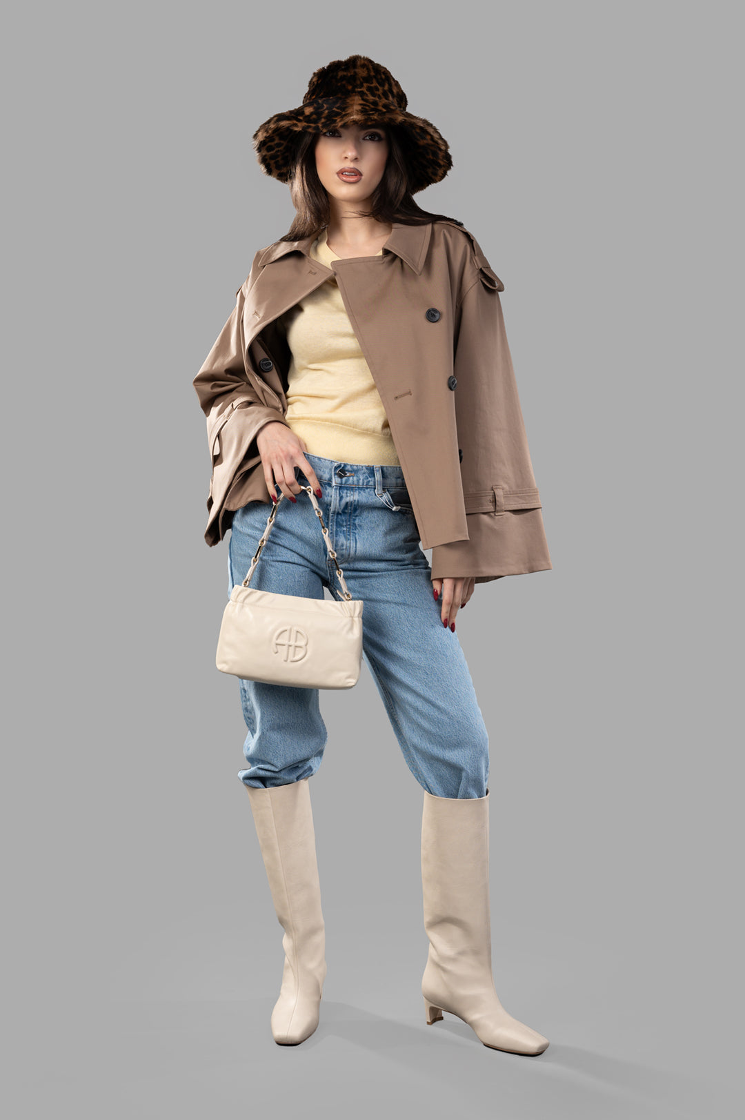 By Malene Birger Alisandra Trench Jacket, front view on model, paired with jeans, boots, hat, and handbag.