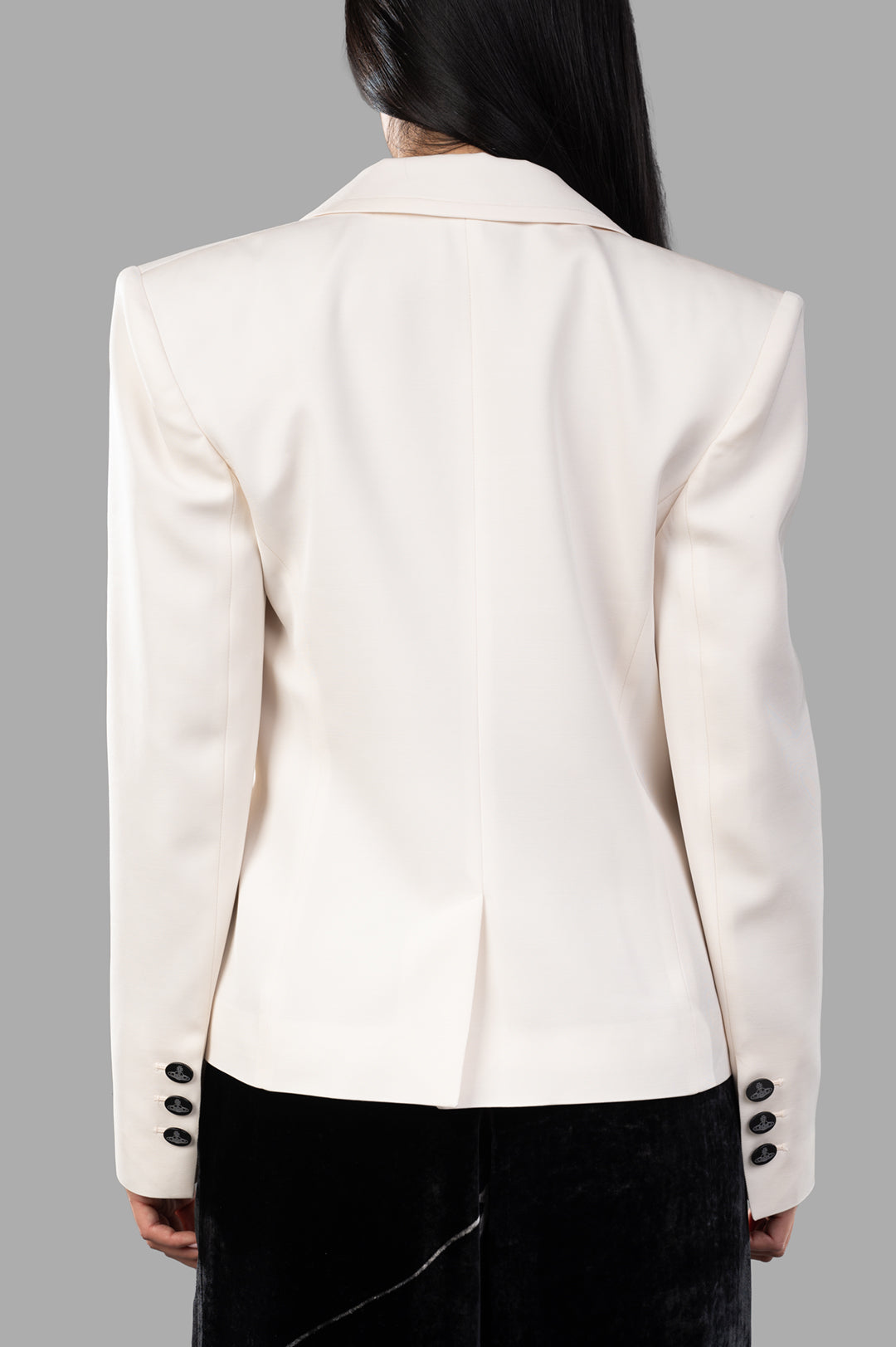 Vivienne Westwood Stewart Jacket shown from the back, featuring off-white fabric and distinct oval-shaped orb buttons.