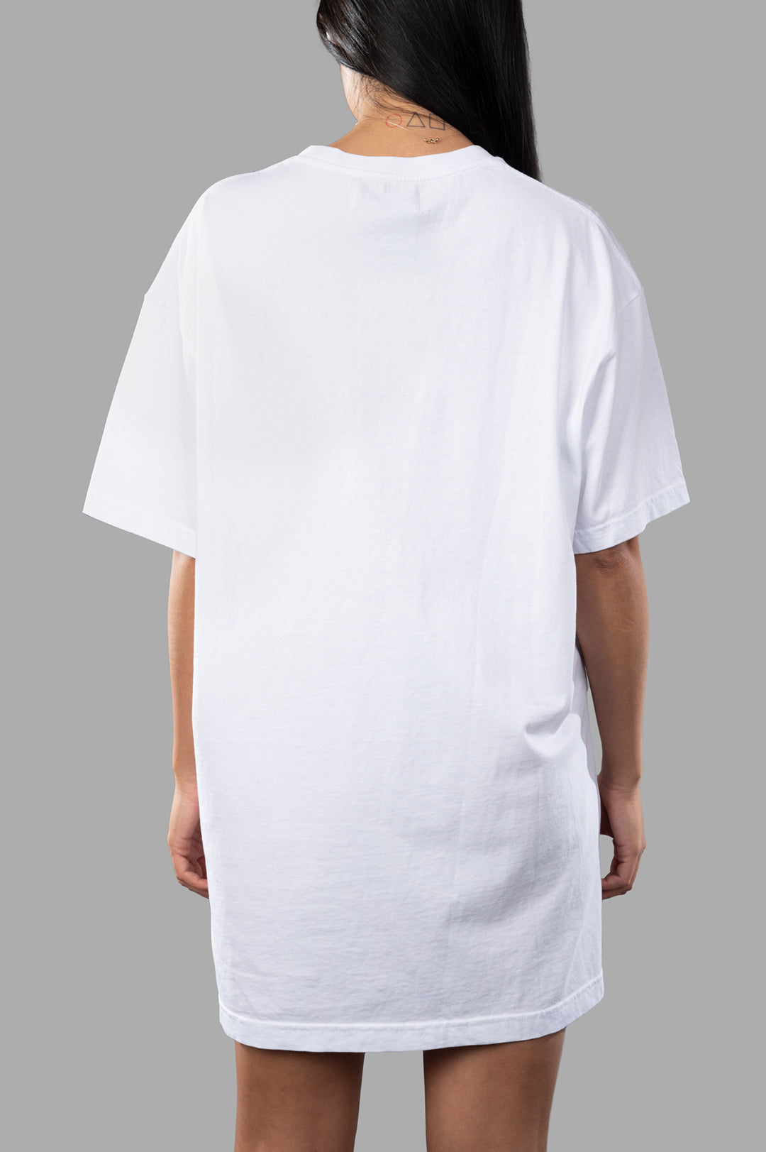 Vivienne Westwood. Back view of a White T-shirt Dress with 3/4 sleeves, showcasing its oversized fit and soft cotton fabric.