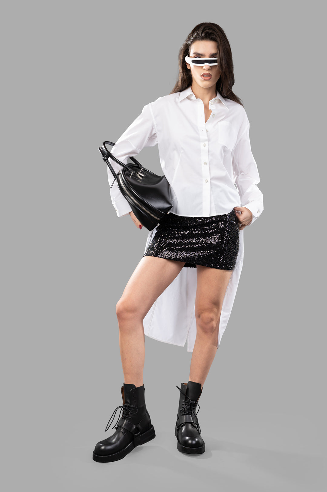 Helmut Lang Apex Tail shirt, front view on-model, white long-sleeve, paired with black skirt and boots.