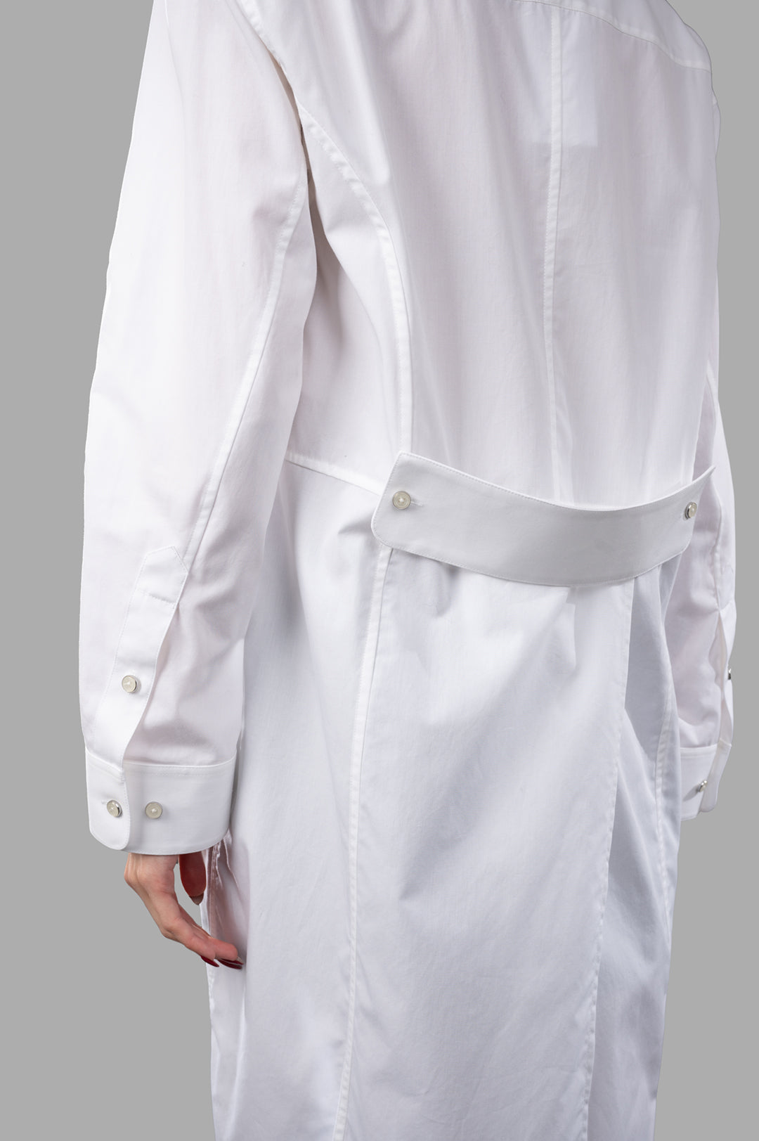 Helmut Lang Apex Tail shirt shown on model, detailing the back design and buttoned sleeves. Stylish and modern look.