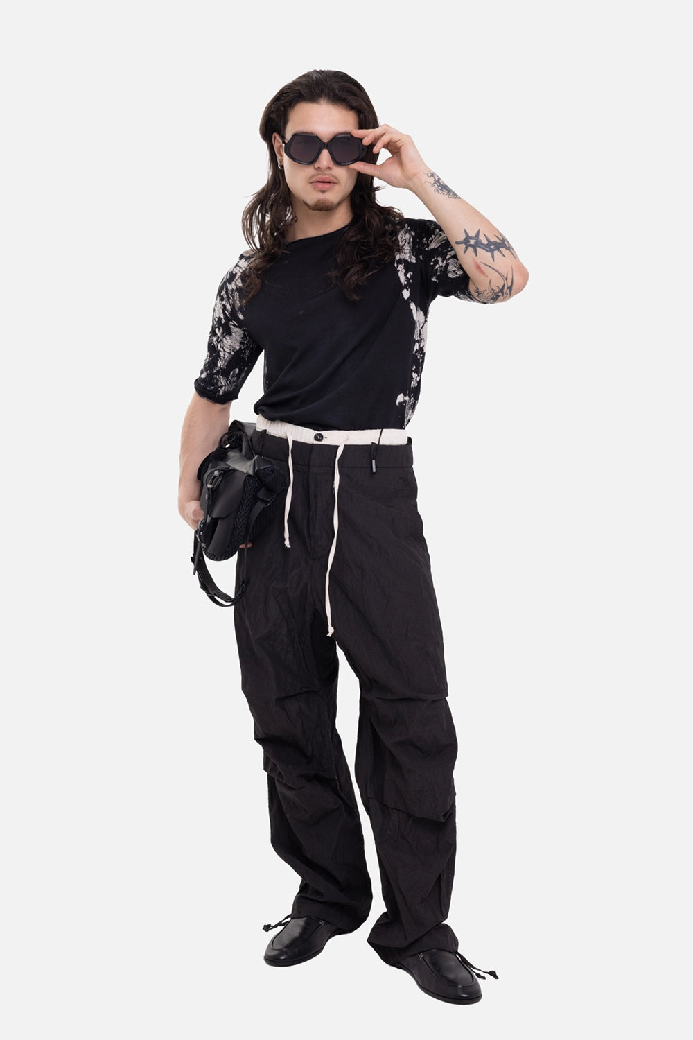 Masnada men's wide-leg pants in black, on-model full-length view, contrast waistband and long drawstring