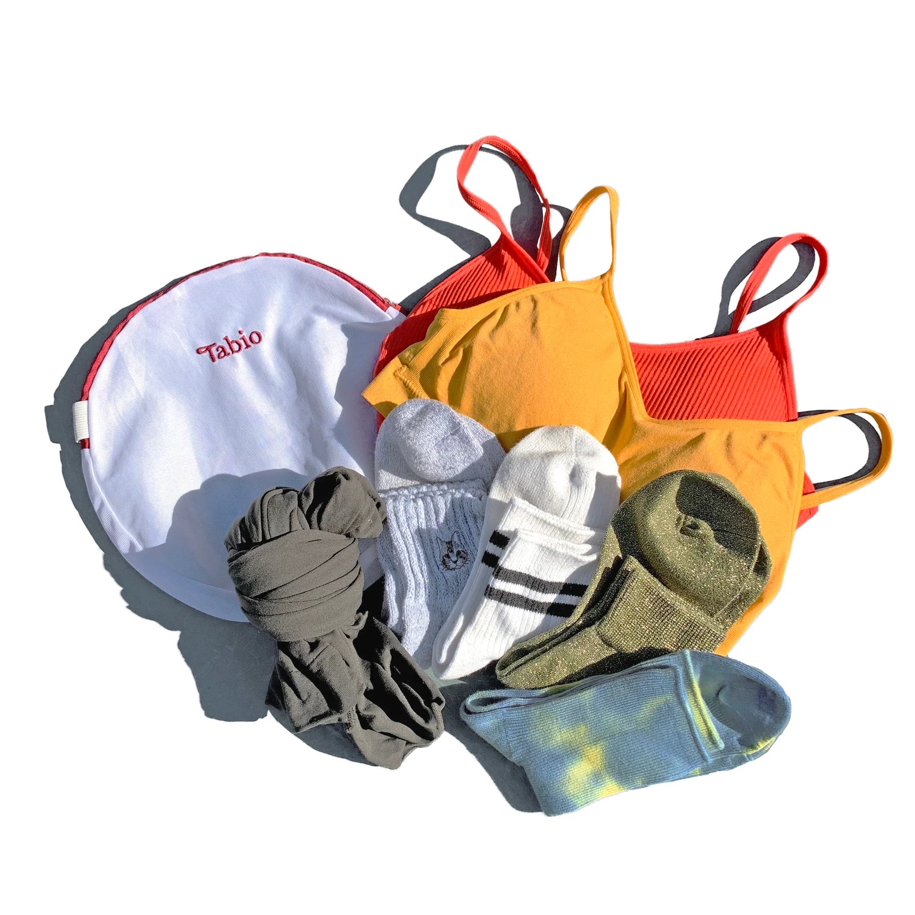 Tabio. Sock Washing Net displayed with colorful lingerie and various socks, designed to protect delicate items in wash.
