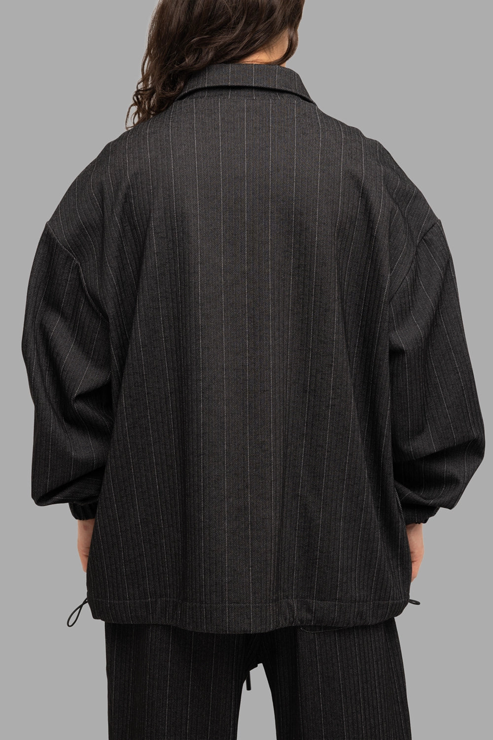 Gaëlle Paris men’s zip jacket in black, back view, dropped shoulders and side hem toggles.