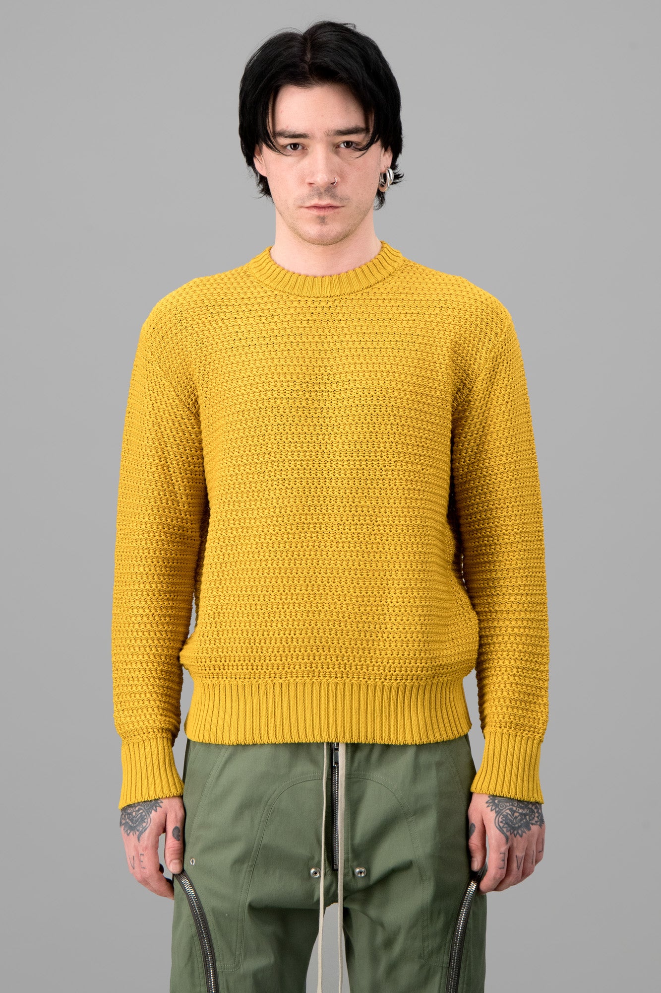AION. Yellow Crew Neck Sweater showcased in a textured knit, featuring ribbed cuffs and hem, worn by a model.