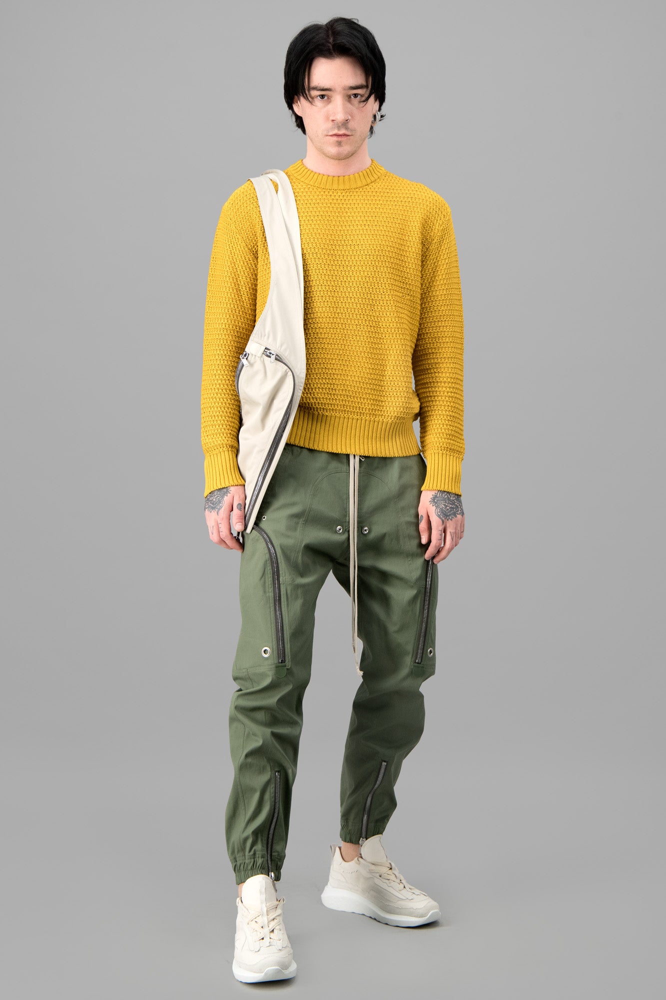 AION Yellow Crew Neck Sweater on model, showcasing front view with ribbed neckline, cuffs, and hem in cotton knit.
