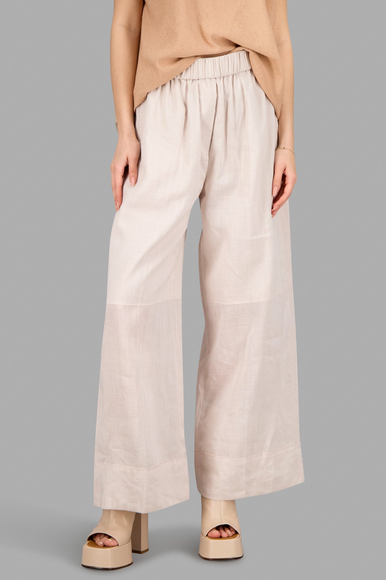 Joseph Elasticated Wide-Leg Trousers in blush, featuring an elasticated waistband and cropped ankle length on model.