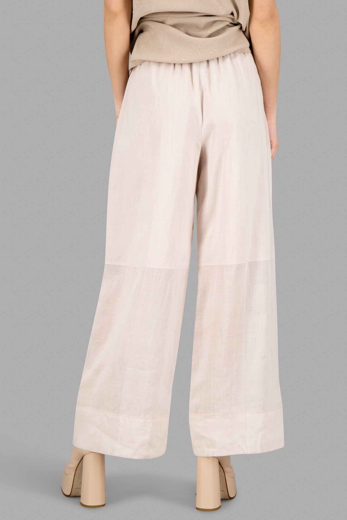 Joseph Elasticated Wide-Leg Trousers in blush, showcasing back view, elastic waistband, and flowing, cropped design.