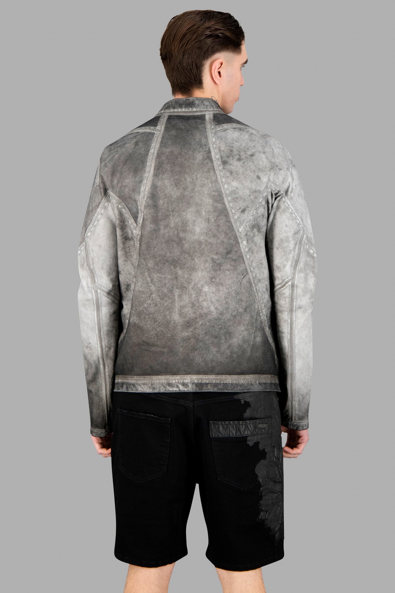 Isaac Sellam Reversible Leather Jacket seen from the back, showcasing sleek plomb-colored lambskin and stylish design.