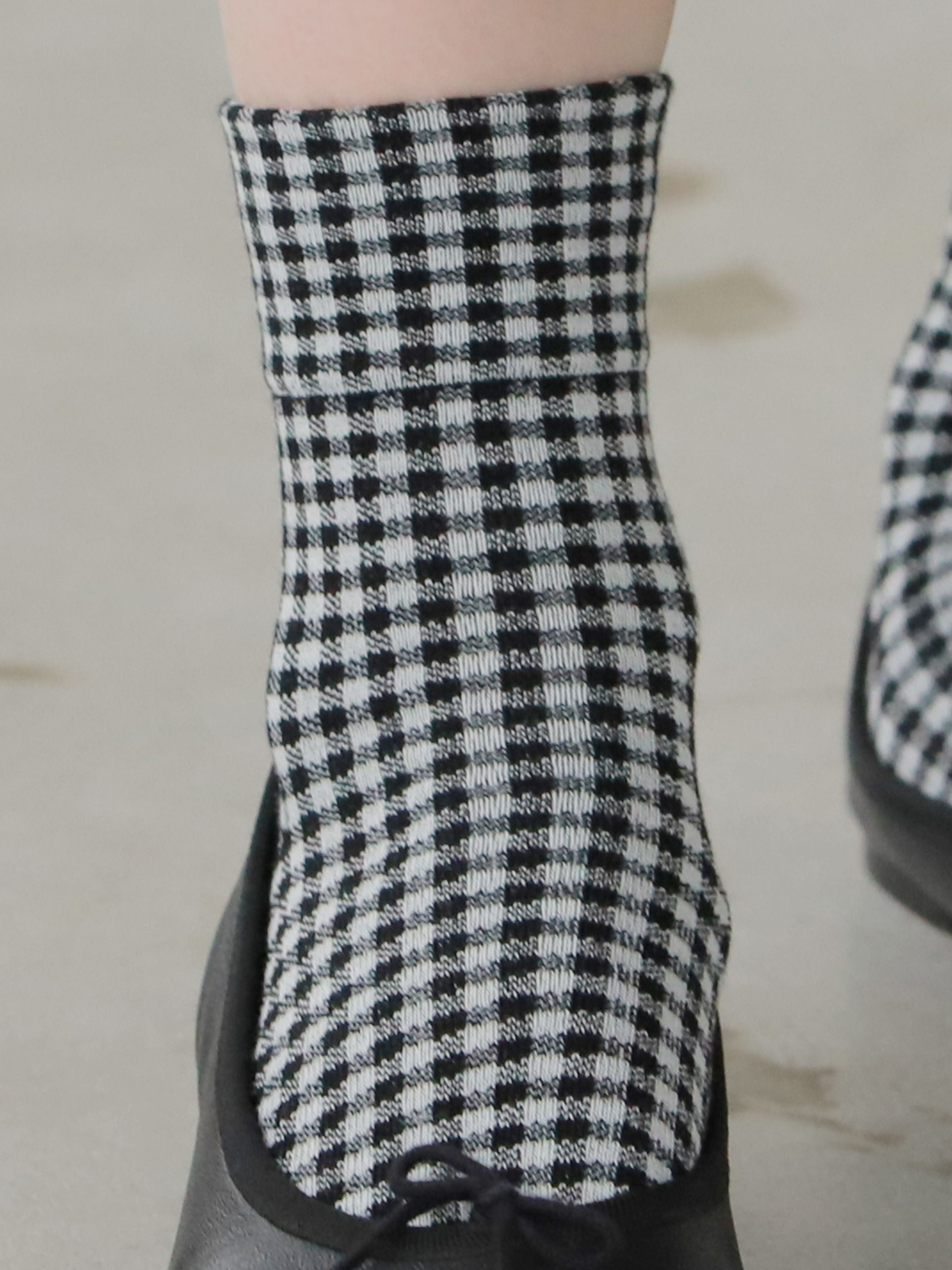 Tabio Vichy Checkered Socks in black and white, showcasing a close-up of the soft, medium gauge cotton texture on a model.