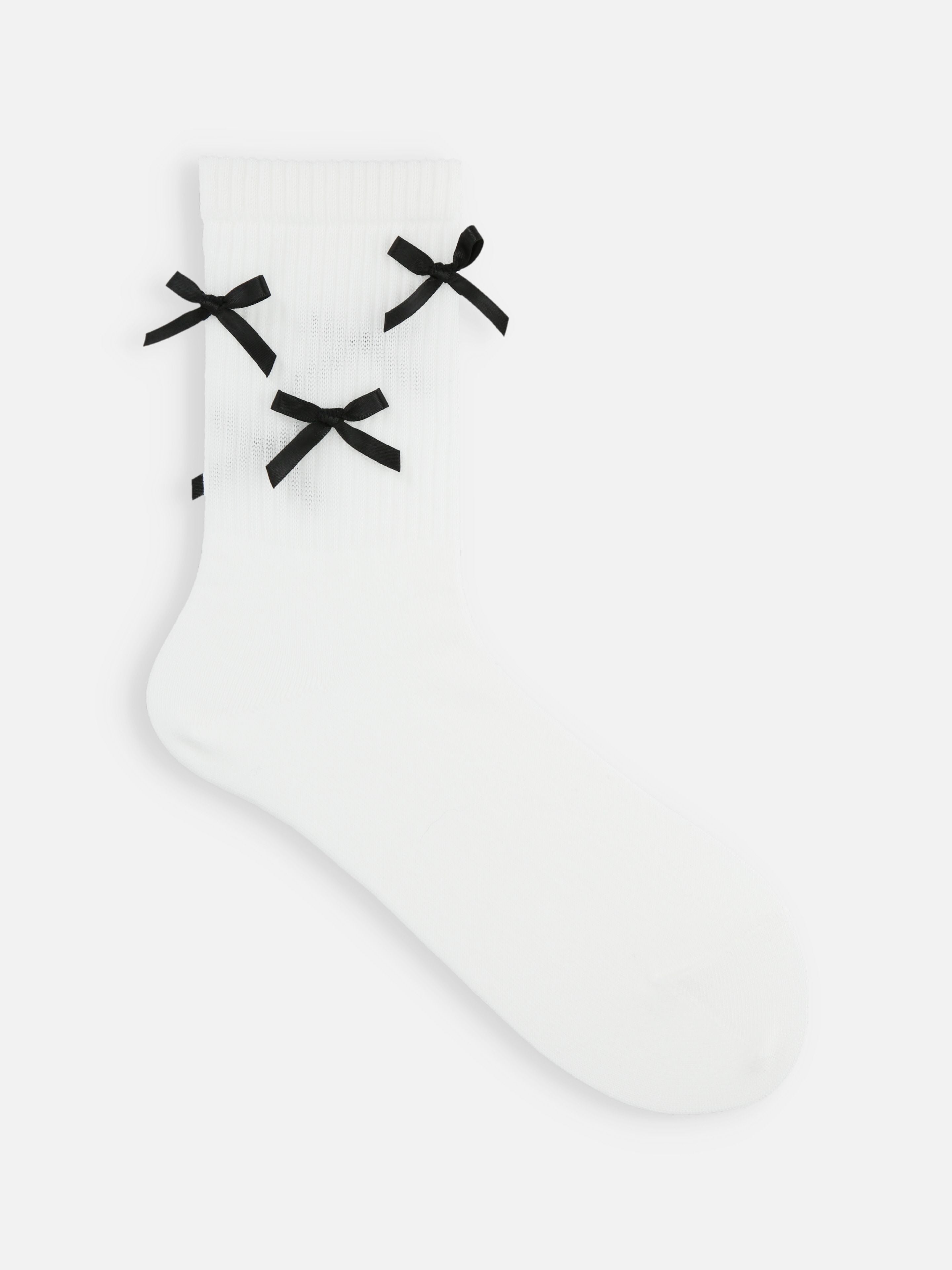 Tabio Satin Ribbons Crew Socks, side view of white ribbed socks with black satin bows for an elegant and trendy look.