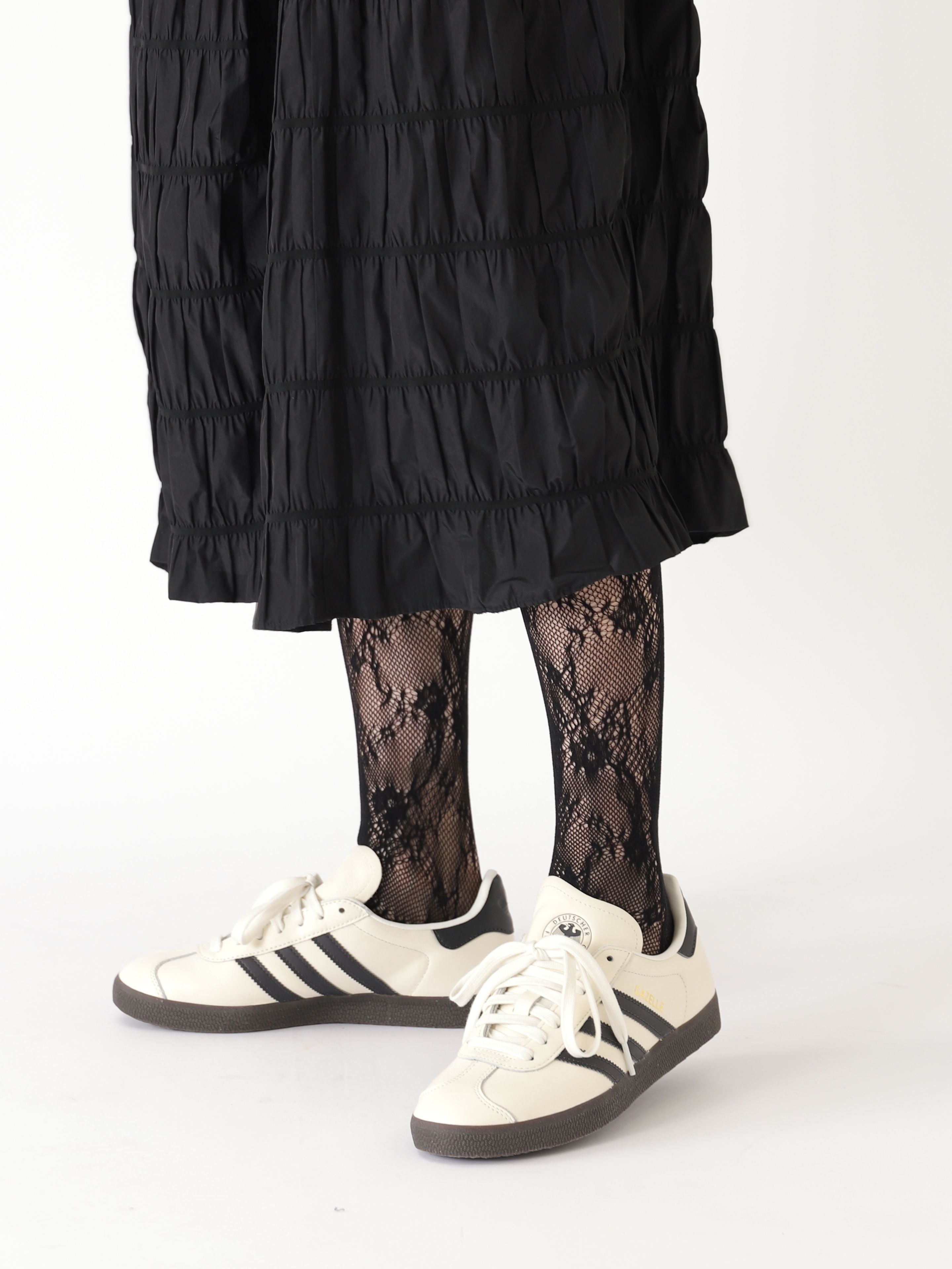 Tabio Raschel Lace Tights showcased with a casual outfit, highlighting their feminine floral pattern and soft texture.