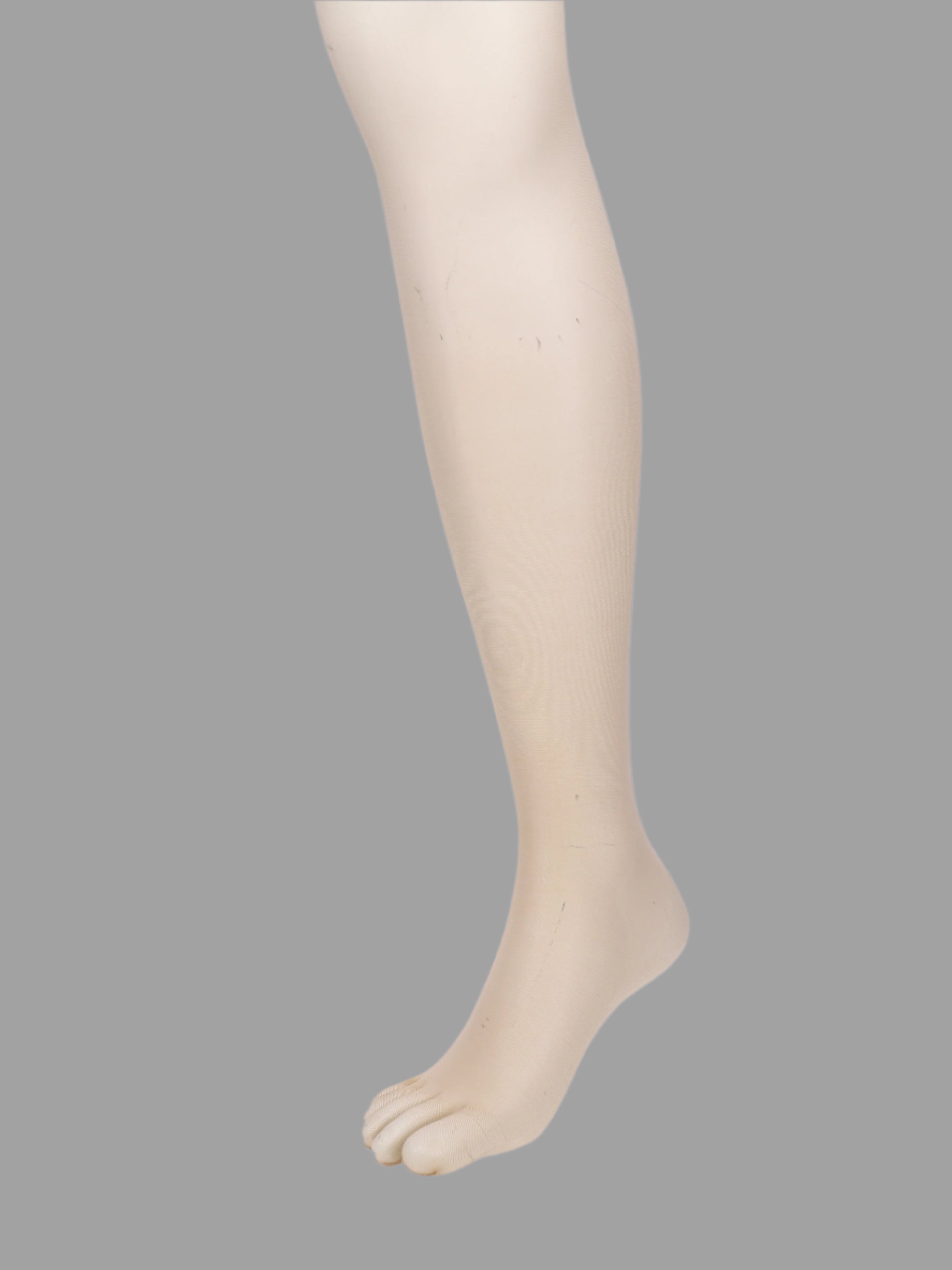 Tabio 20D Sheer Tights, nude, side view on-model showing split-toe tabi foot detail.