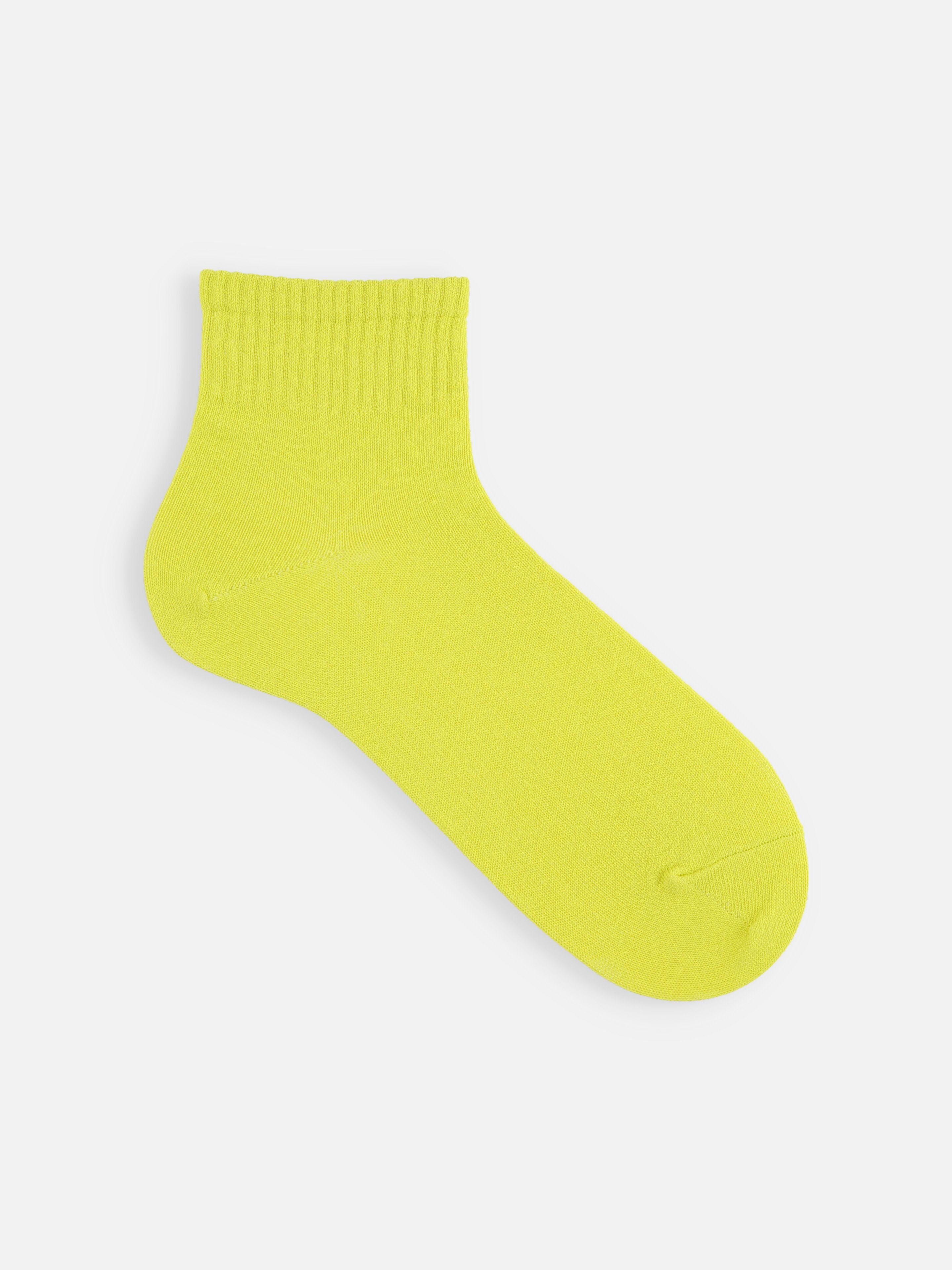 Tabio Xylitol Cool Touch Rib Ankle Socks in vibrant neon yellow; close-up view showcasing smooth texture and ribbed cuff.