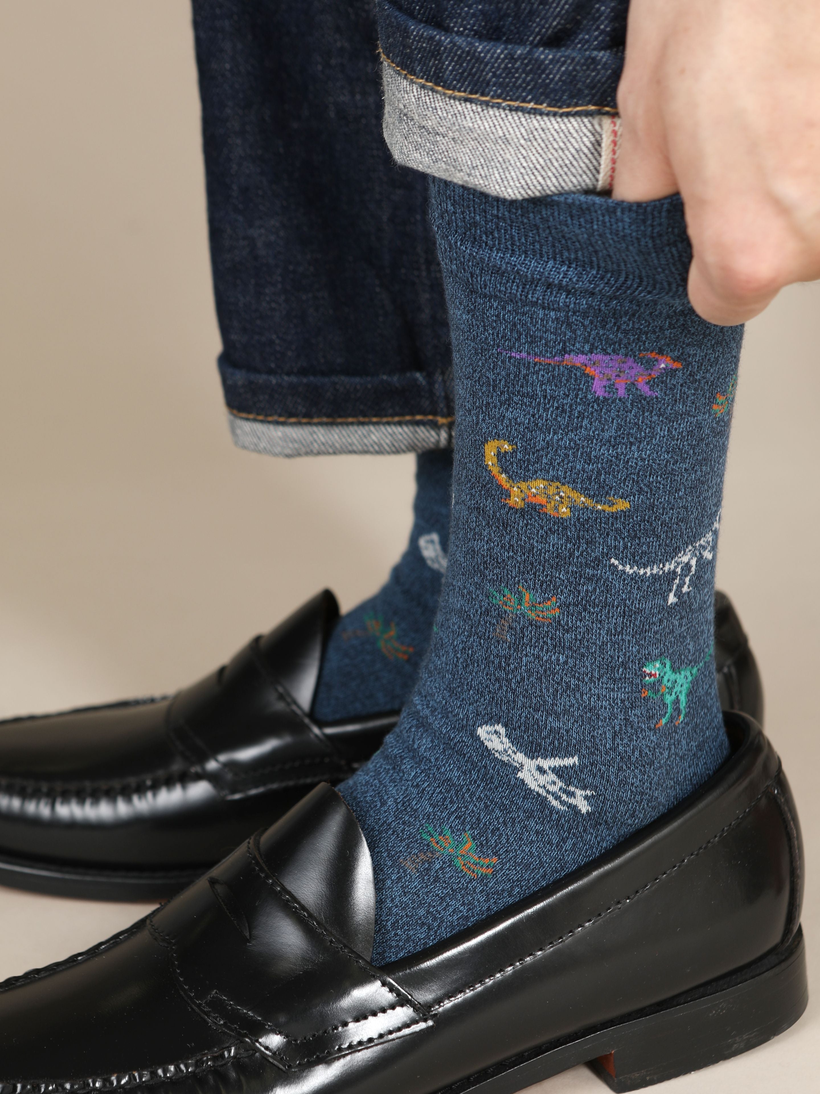 Tabio. Dinosaur-Pattern Crew Socks featuring colorful dinosaur motifs, styled elegantly with loafers and denim.