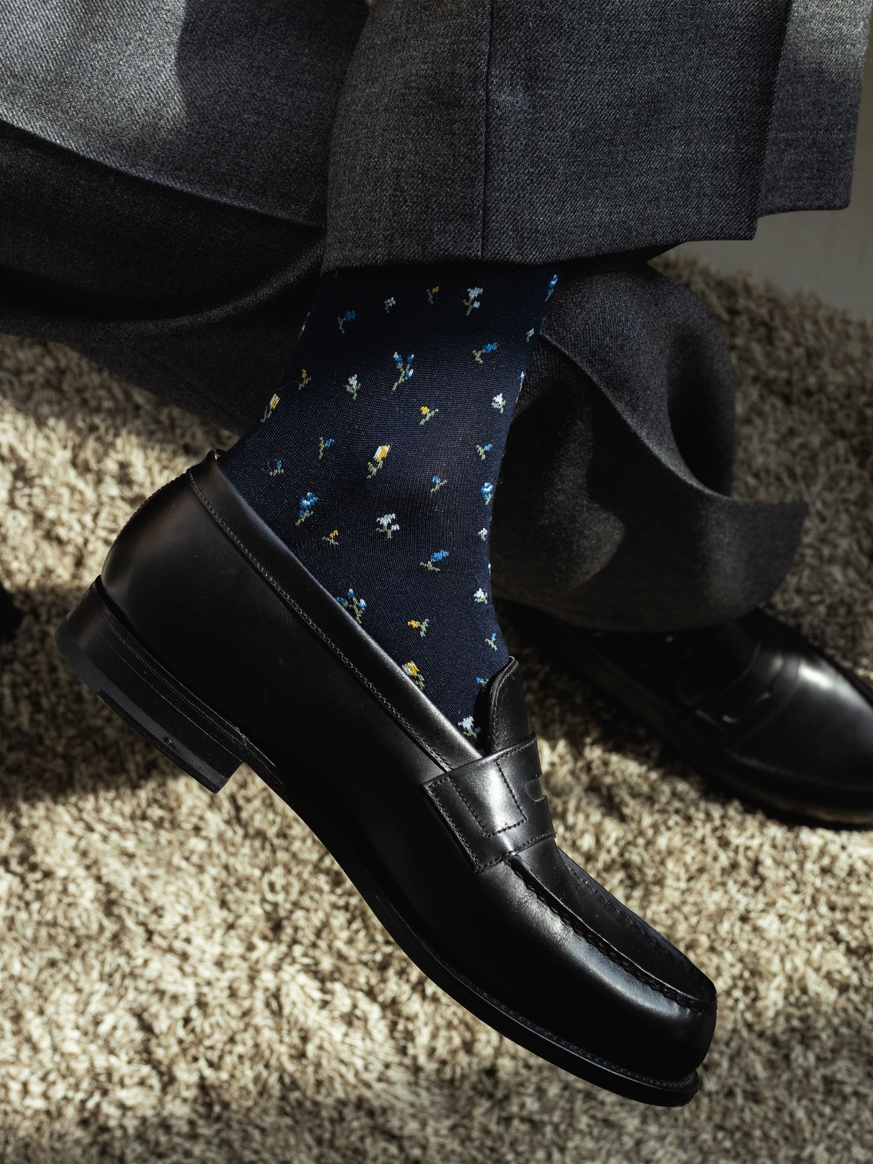 Tabio Supima Small Floral Print Socks showcased on a model's foot, featuring a dark navy background with colorful floral.
