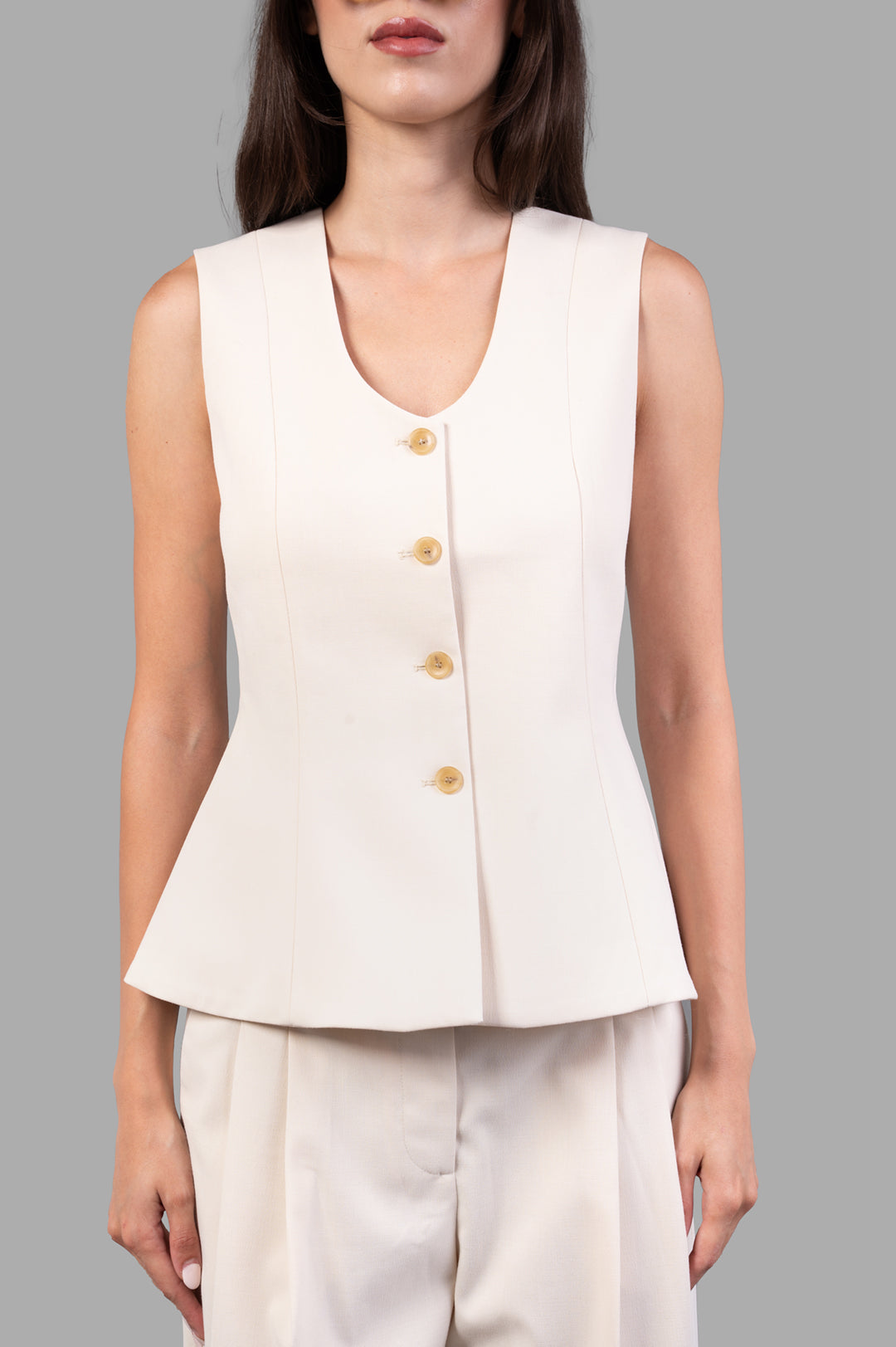 By Malene Birger Merlin Waistcoat in pearl, showcasing a close-up of the deep neckline and button details on a model.