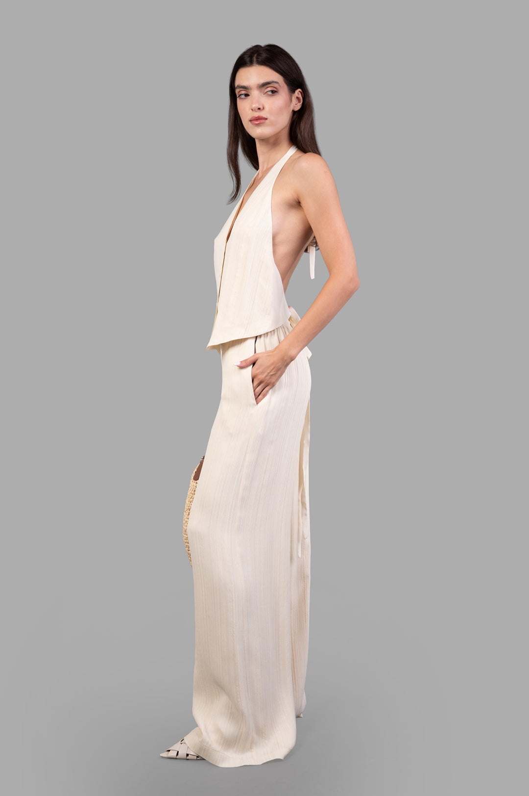 Joseph Suez Pleat Jacquard Tie Waistcoat, halter neck with linear texture, shown in profile on model.
