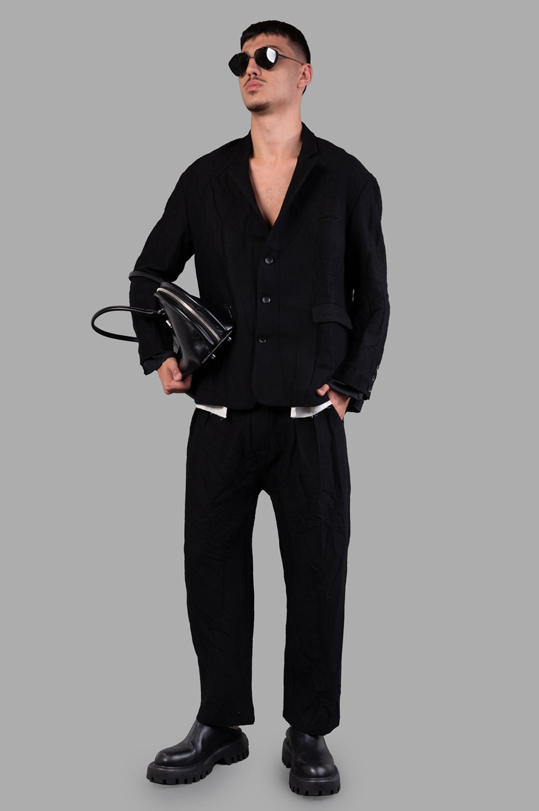 Marc Point Single-breasted Blazer in black wool, front view on model, showcasing layered texture and sleek silhouette.