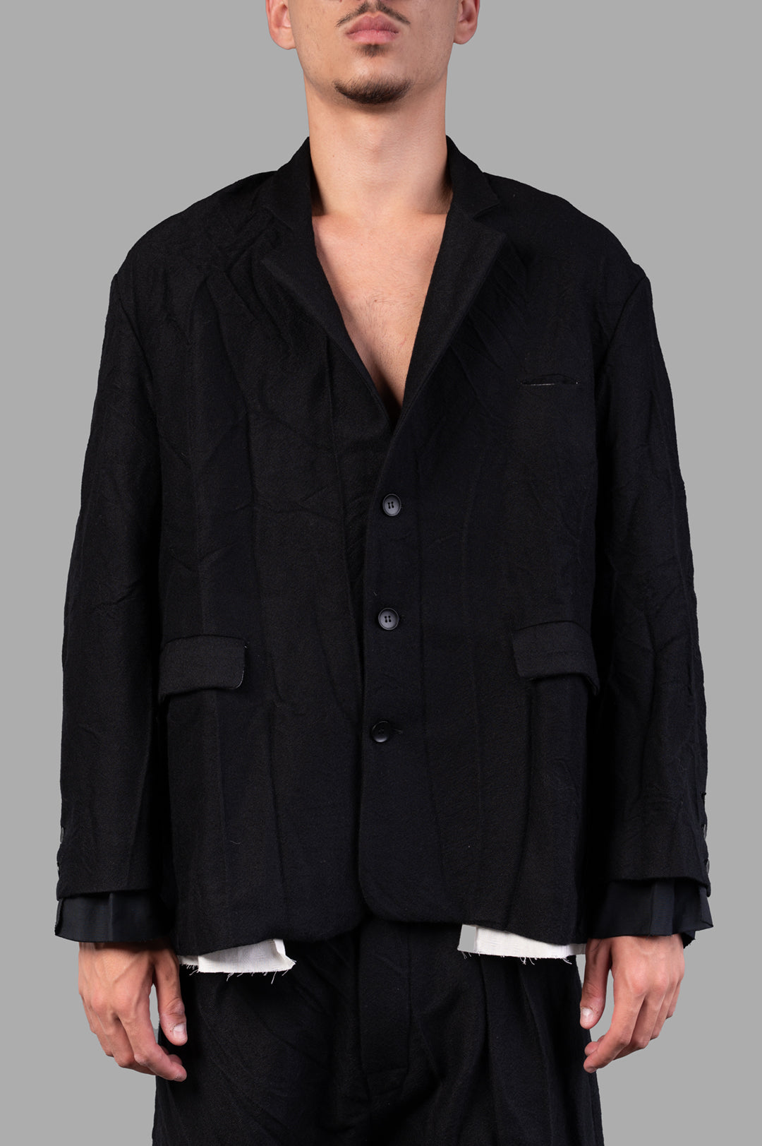 Marc Point Single-breasted Blazer in black, showcasing a textured wool fabric and sophisticated front view on model.