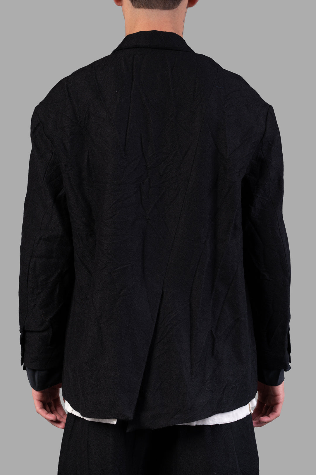 Marc Point Single-breasted Blazer shown from the back, featuring a textured black wool fabric and sleek silhouette.