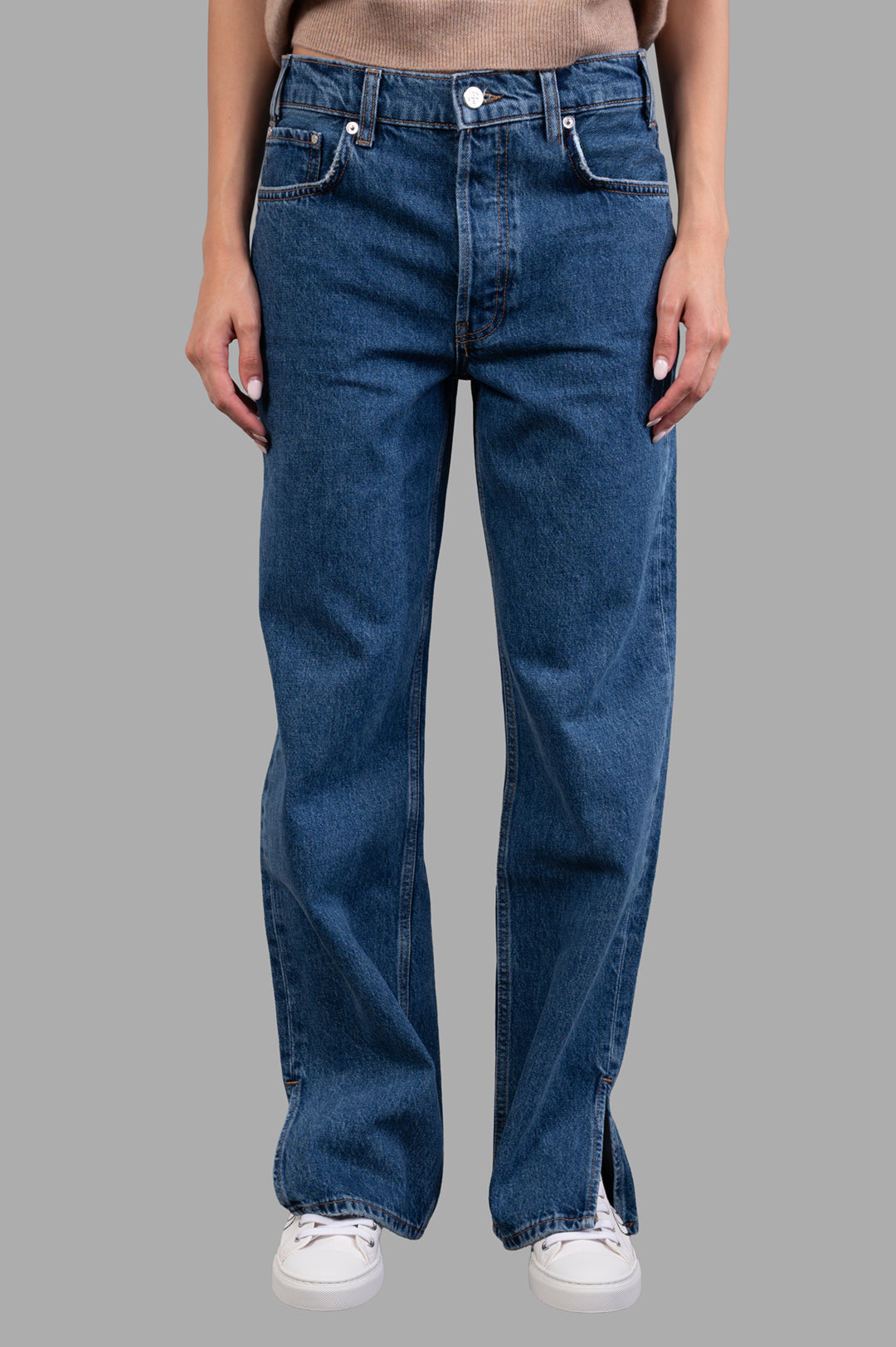 Anine Bing Roy Jeans displayed on model, showcasing relaxed fit, midweight cotton in clean blue wash with side slits.