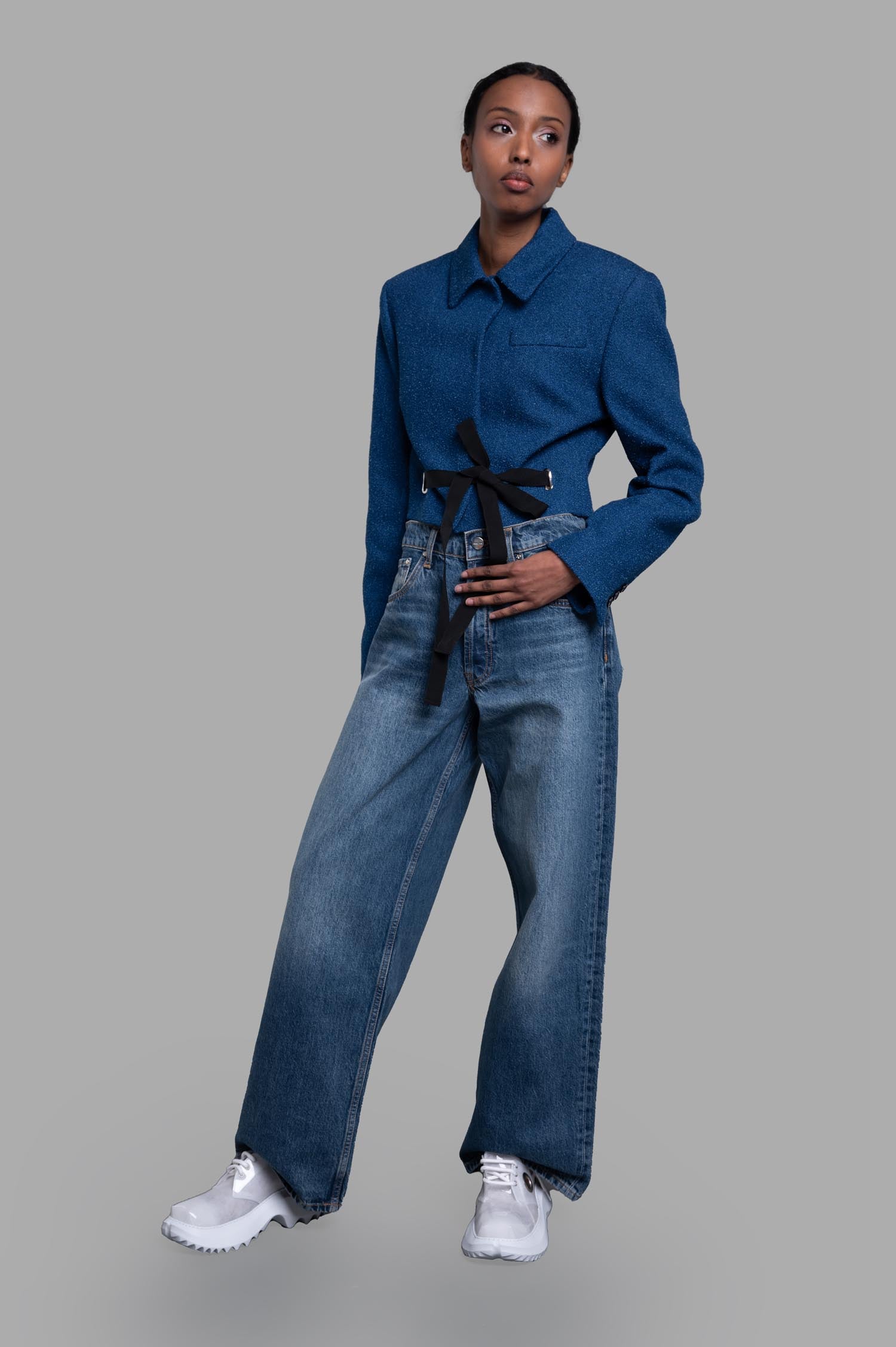 MSGM Cropped Drawstring Blazer in blue, front view on-model, showcasing classic collar and adjustable bow tie waist.