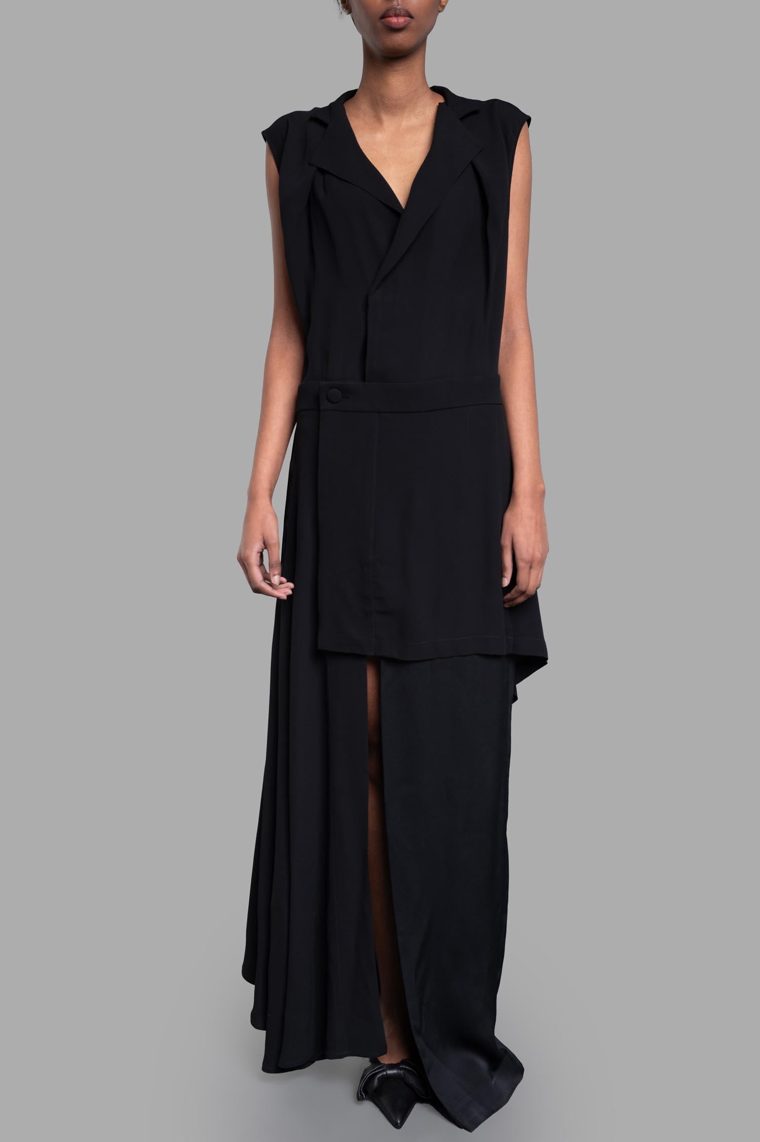 Vivienne Westwood. Layered Dress in black, featuring asymmetrical layers, cap sleeves, and a front slit, shown on model.