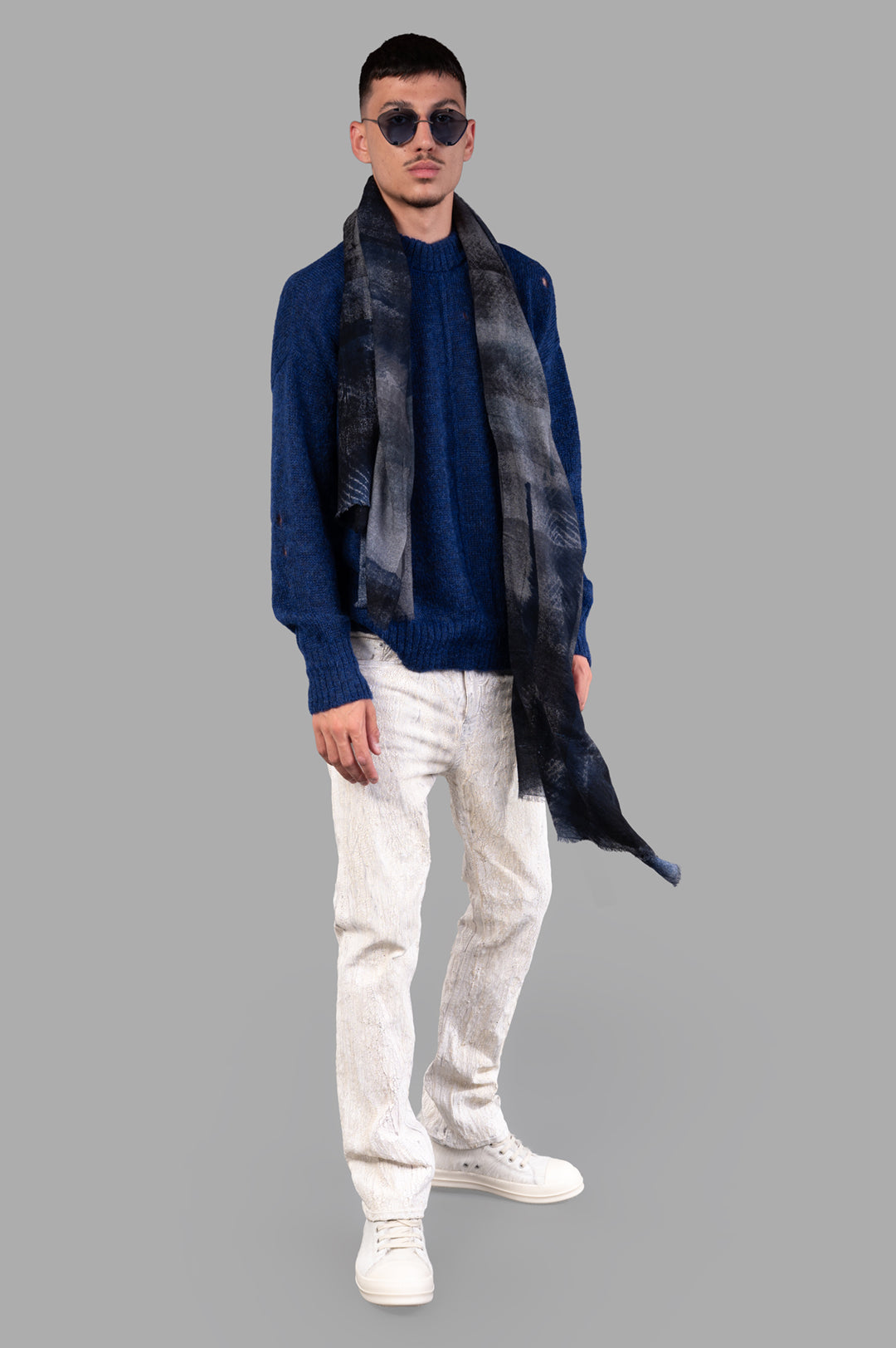 Marc Point Blue Sweater on-model front view with scarf, white jeans, and sneakers.
