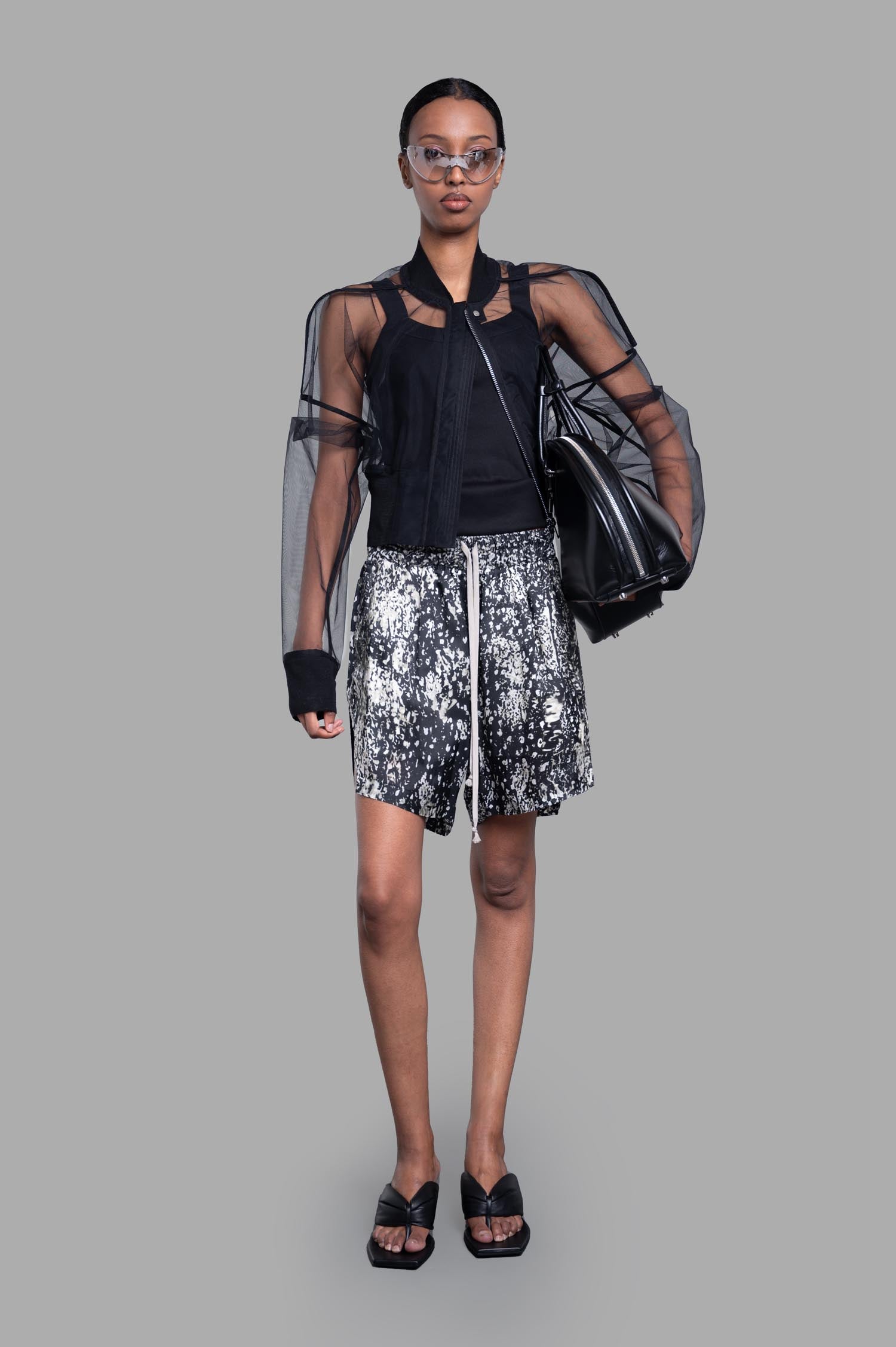 Rick Owens Transparent Cropped Bomber, black nylon, on model, front view showcasing bold, boxy design and sheer sleeves.