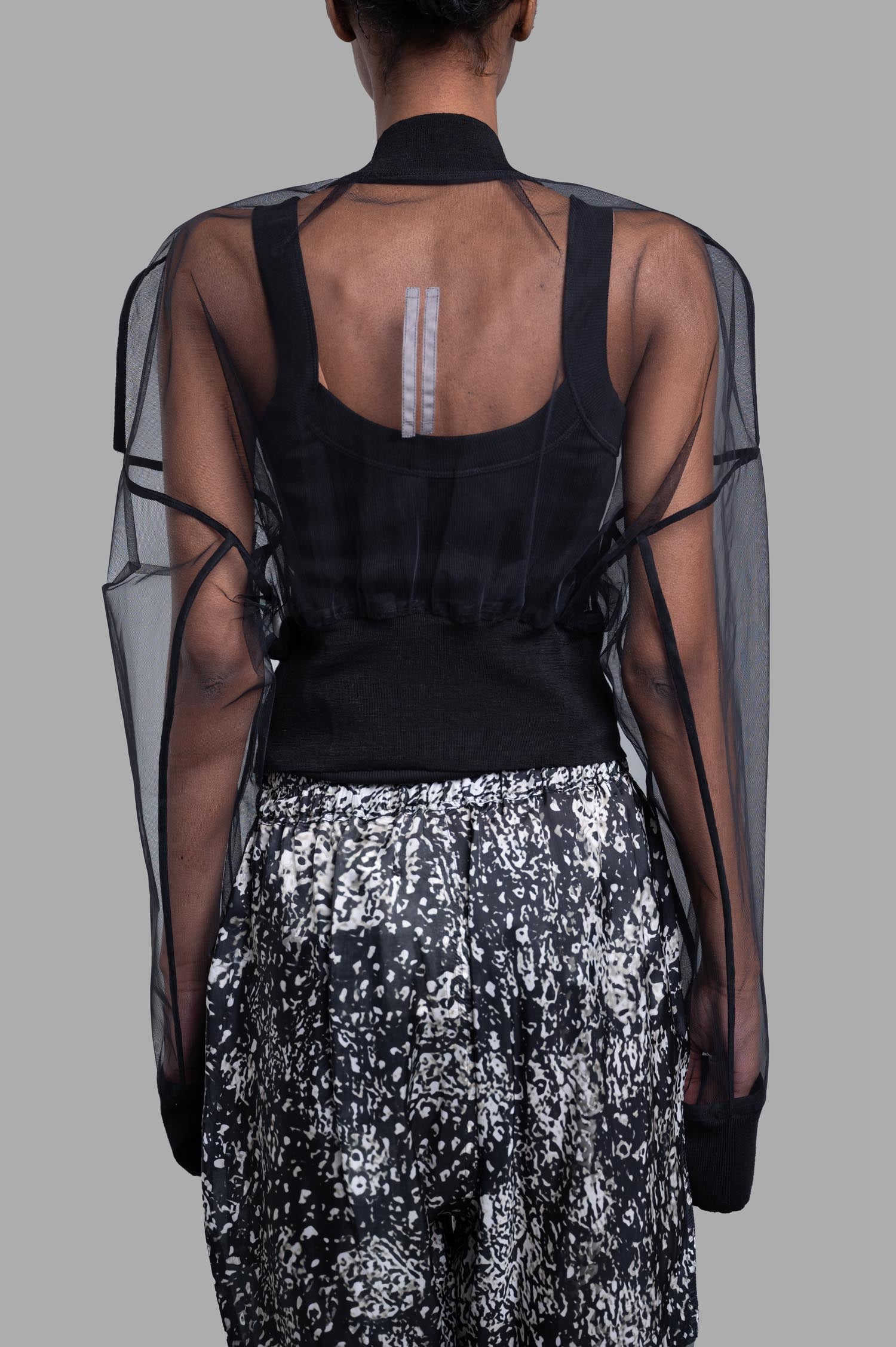 Rick Owens Transparent Cropped Bomber showcased from the back, featuring sheer nylon sleeves and a fitted black body.