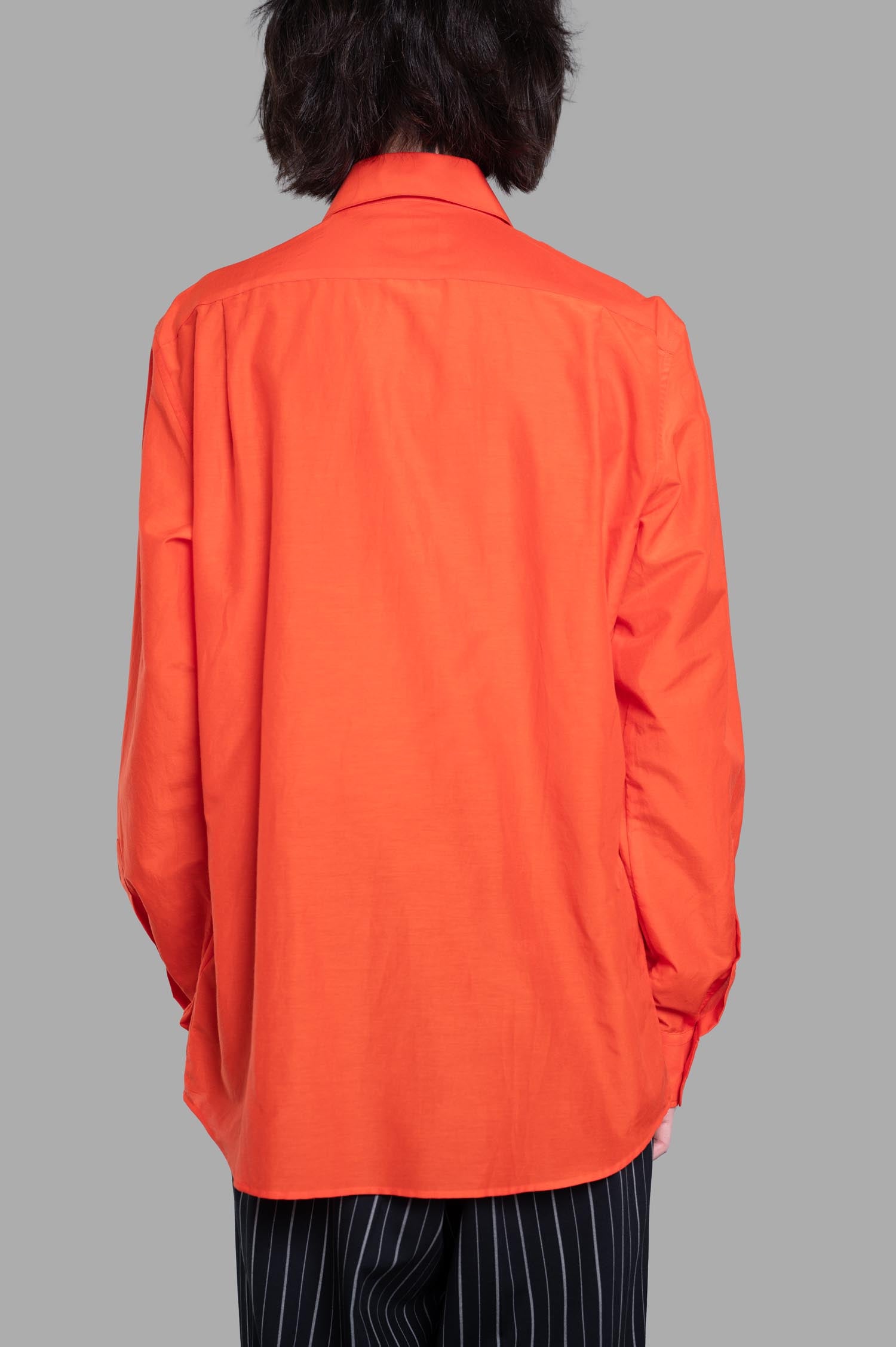 Vivienne Westwood Two-Button Krall Shirt displayed from back, showcasing vibrant orange color and relaxed silhouette in.