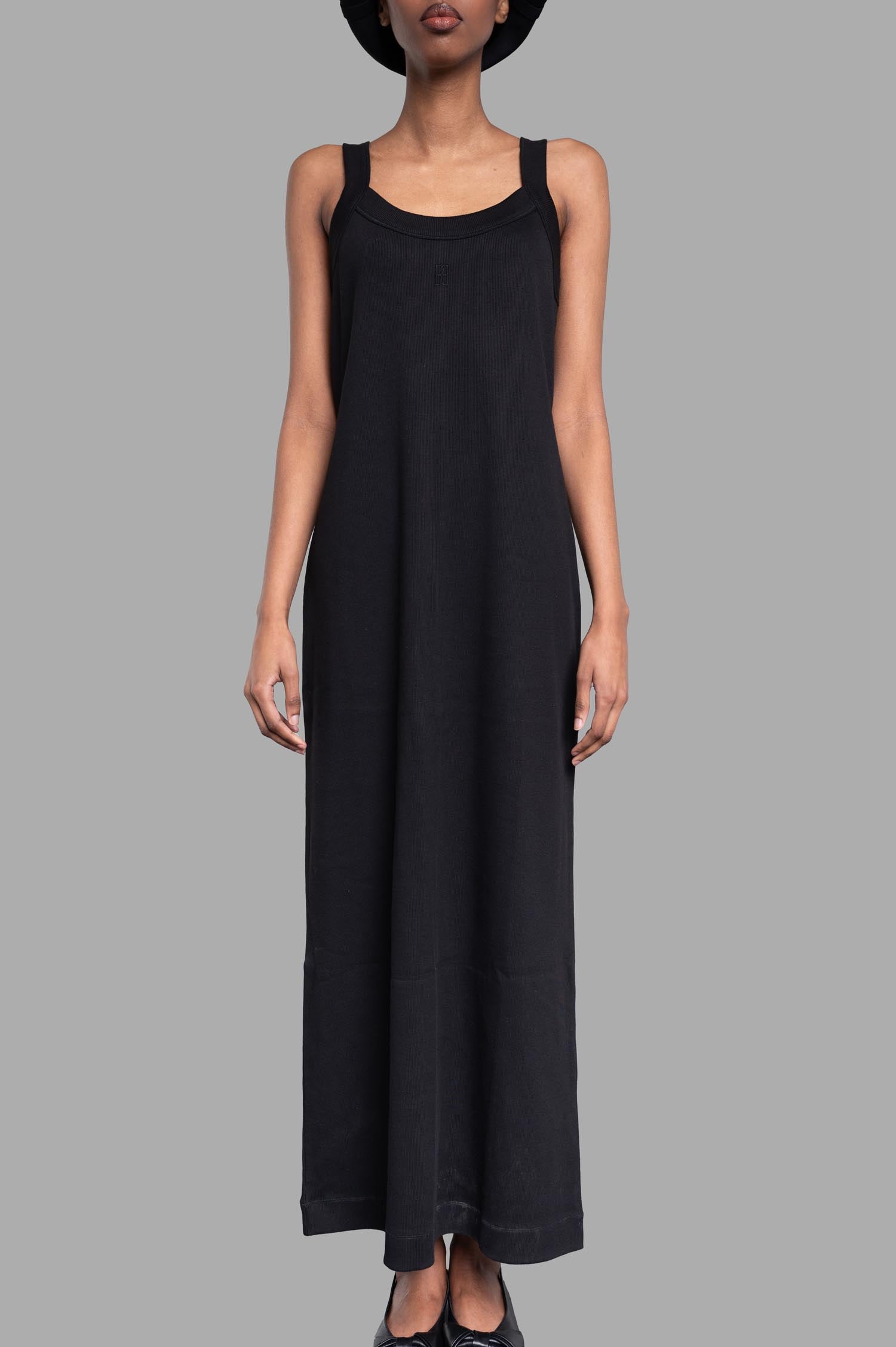 By Malene Birger Lio Maxi Dress in black, showcasing the front view with wide straps and low round neckline on model.