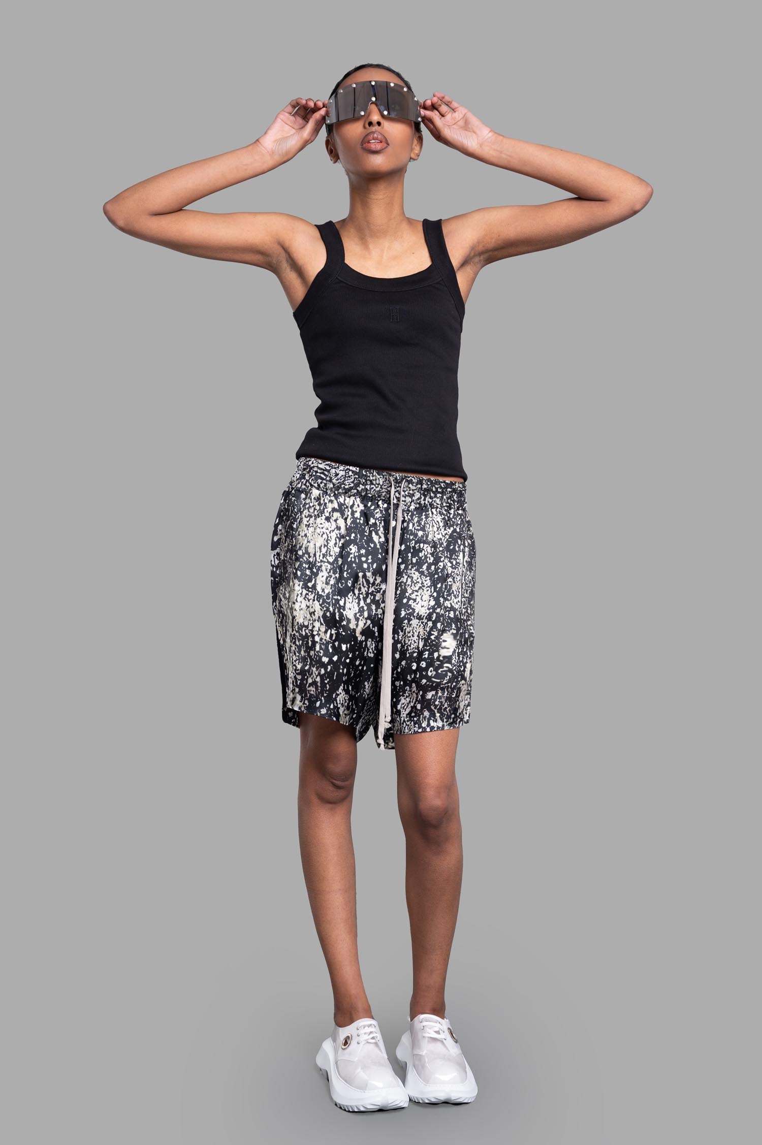 By Malene Birger Frillio Top in black, front view on-model with wide straps and embroidered monogram, casual look.