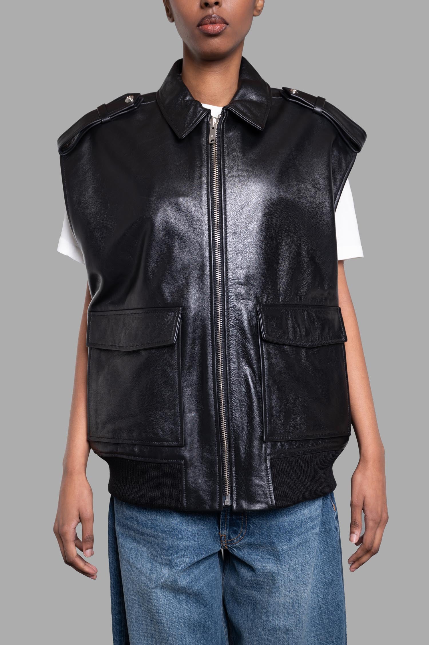 Anine Bing Sonnie Vest in black, featuring oversized design, leather texture, and front pockets on model.