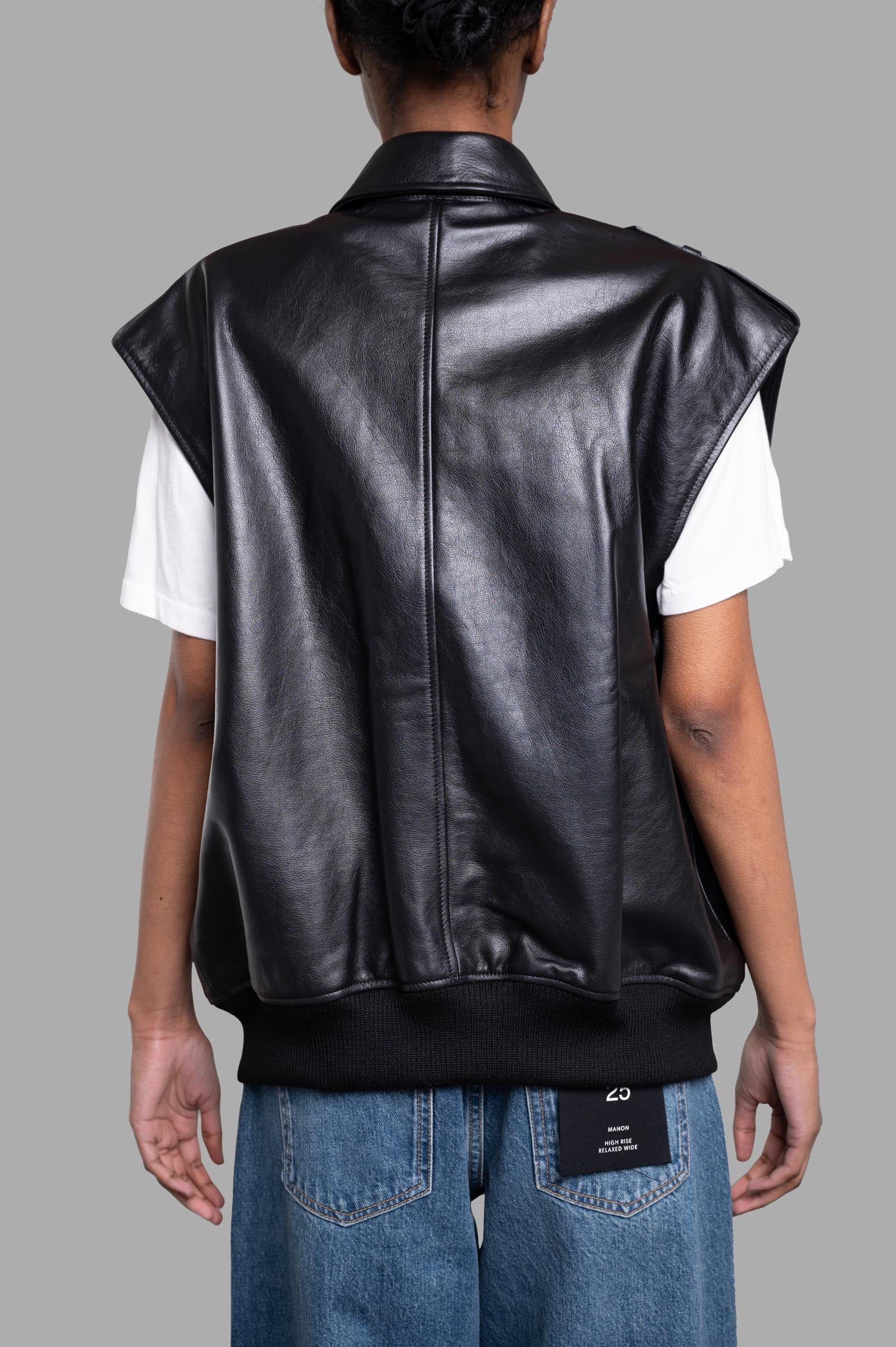 Anine Bing Sonnie Vest shown from the back, featuring heavyweight black leather with ribbed trim and oversized fit.