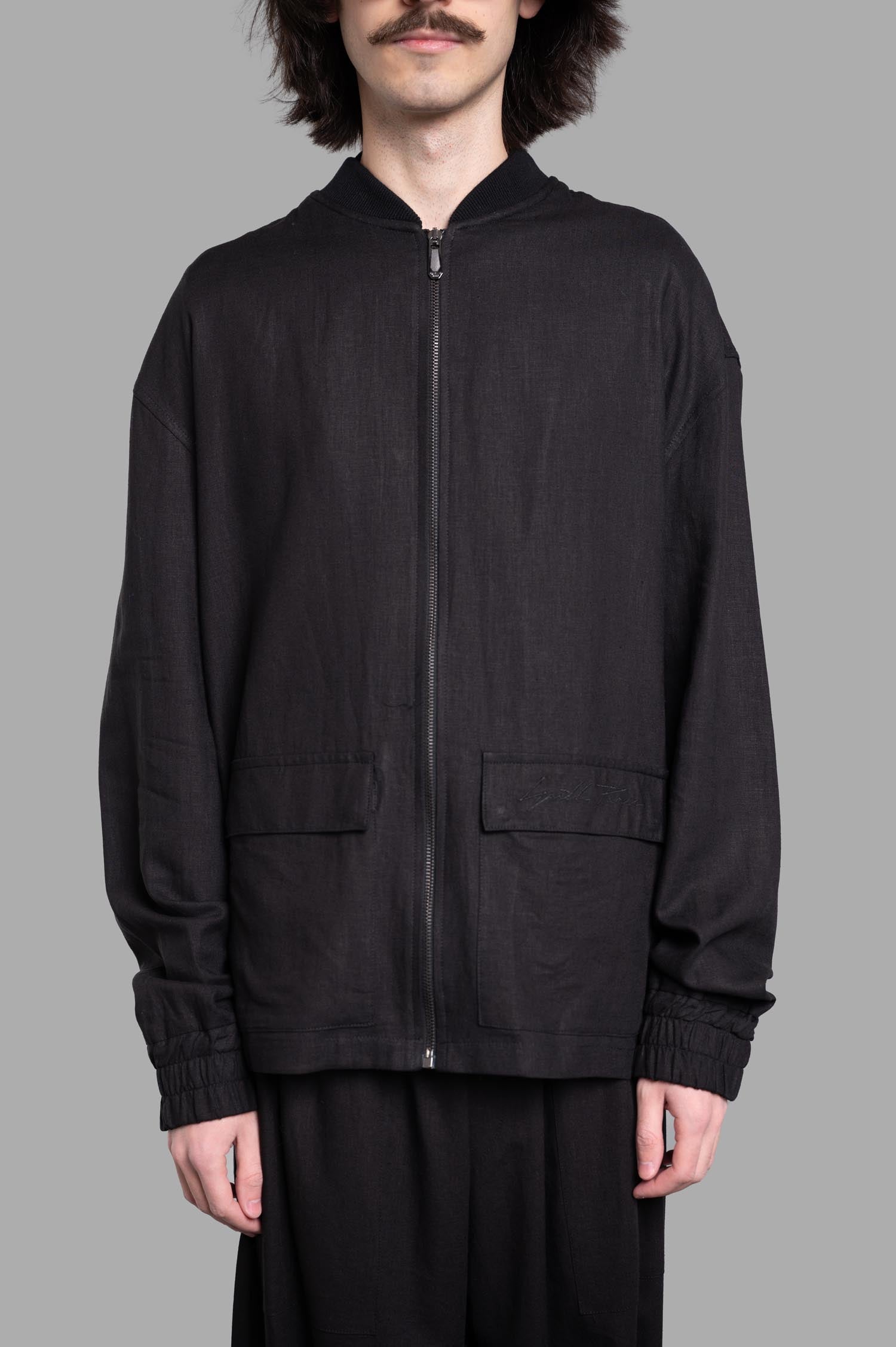 Gaëlle Paris Drawstring Jacket - Black bomber-style jacket with front zip and unique back drawstrings for a stylish look.