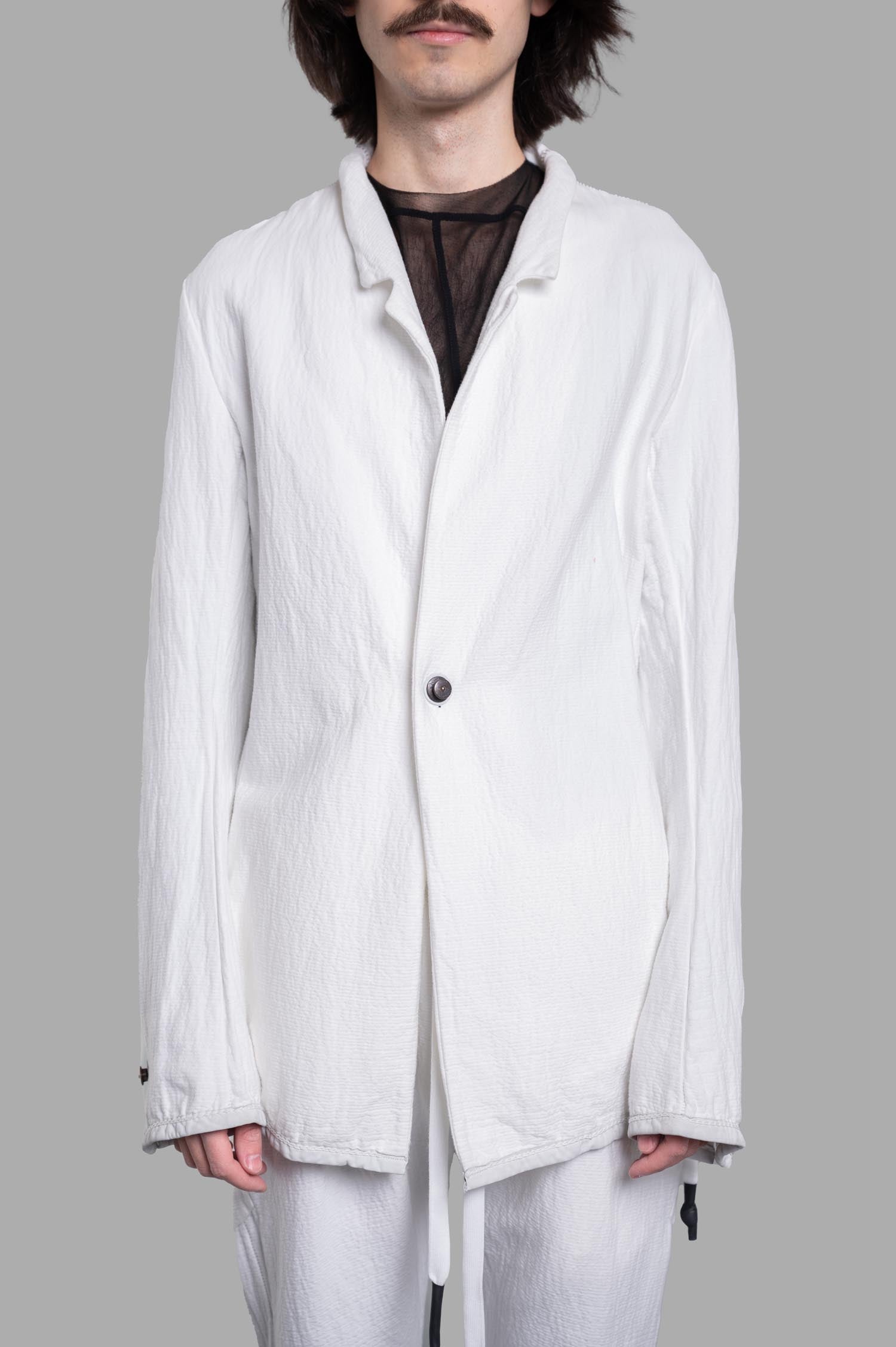 Isaac Sellam Crinkled Blazer in white, featuring unique collar design, leather piping, and bold chain detail on sleeves.