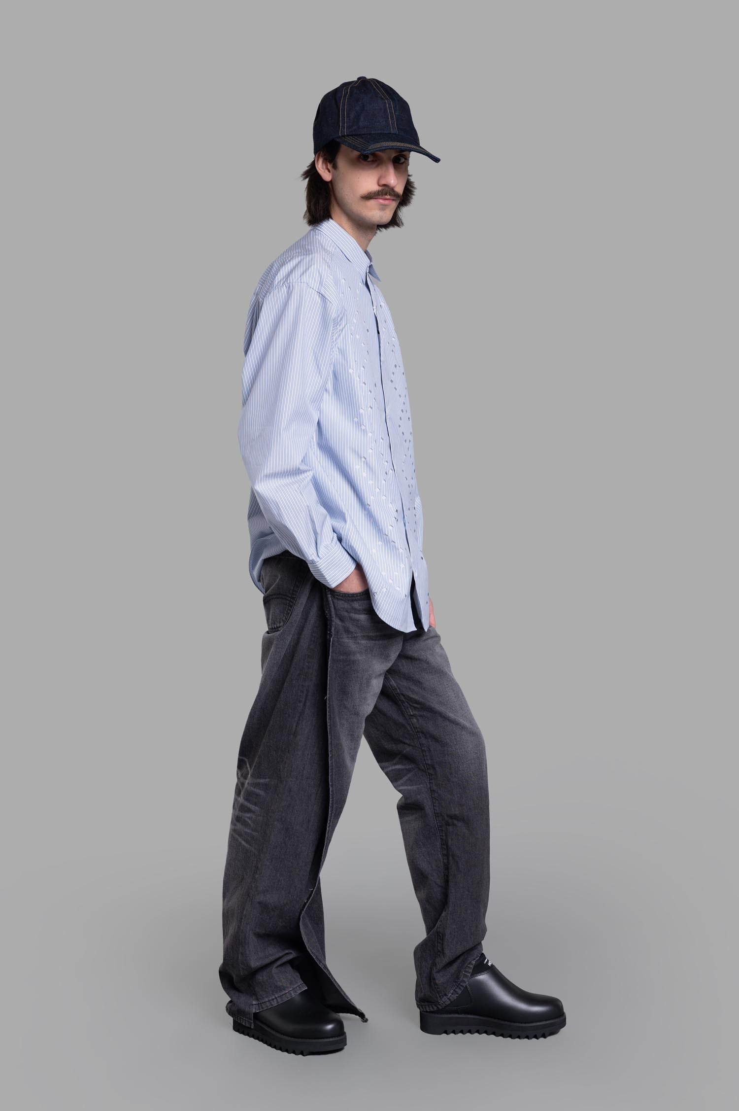 Comme des Garçons Striped Poplin Shirt in blue, side view on model. Features geometric patterns, made from cotton-poly blend.