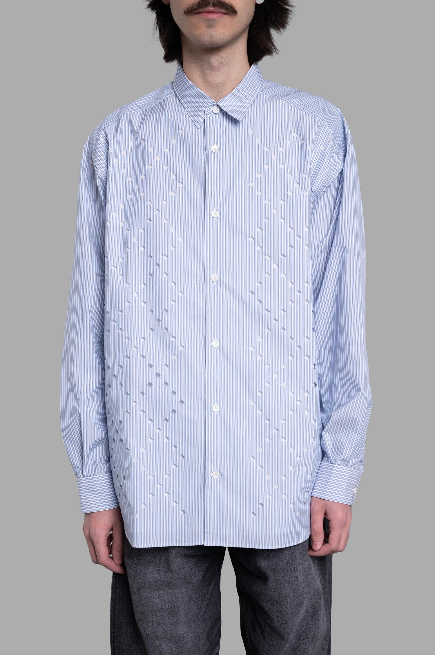 Comme des Garçons Striped Poplin Shirt in powder blue features delicate pinstripes and geometric patterns on a model.