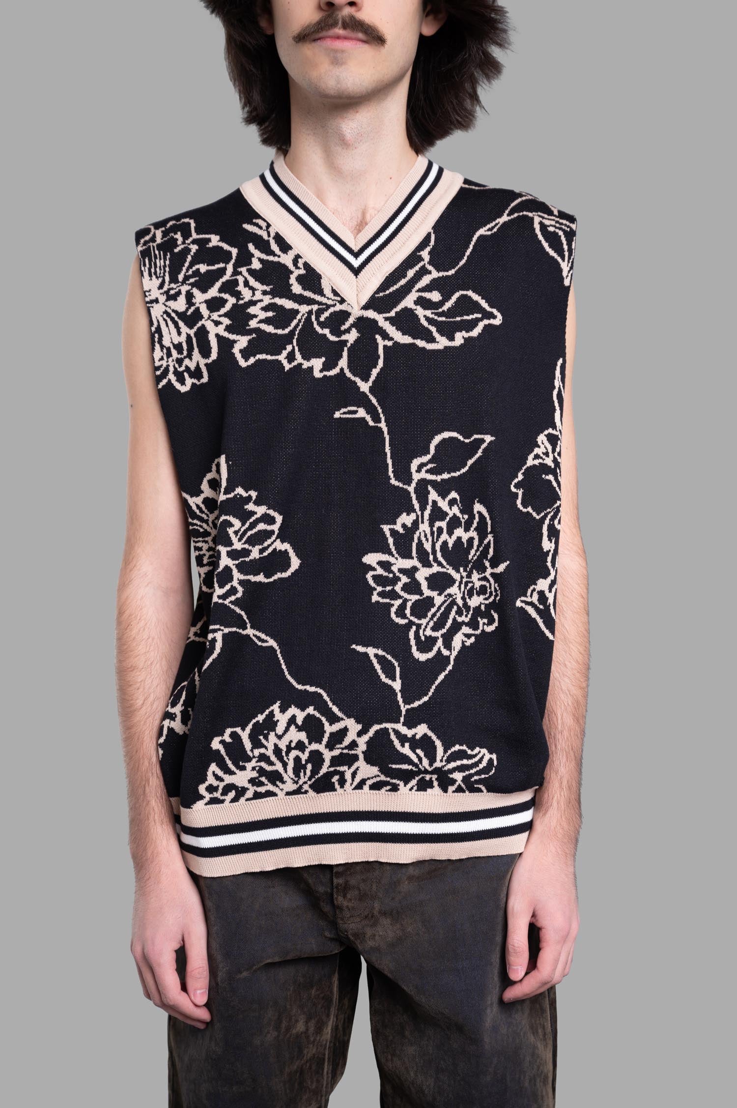 Gaëlle Paris Floral Vest in black with V-neckline, showcasing a detailed all-over floral print, worn by a model.
