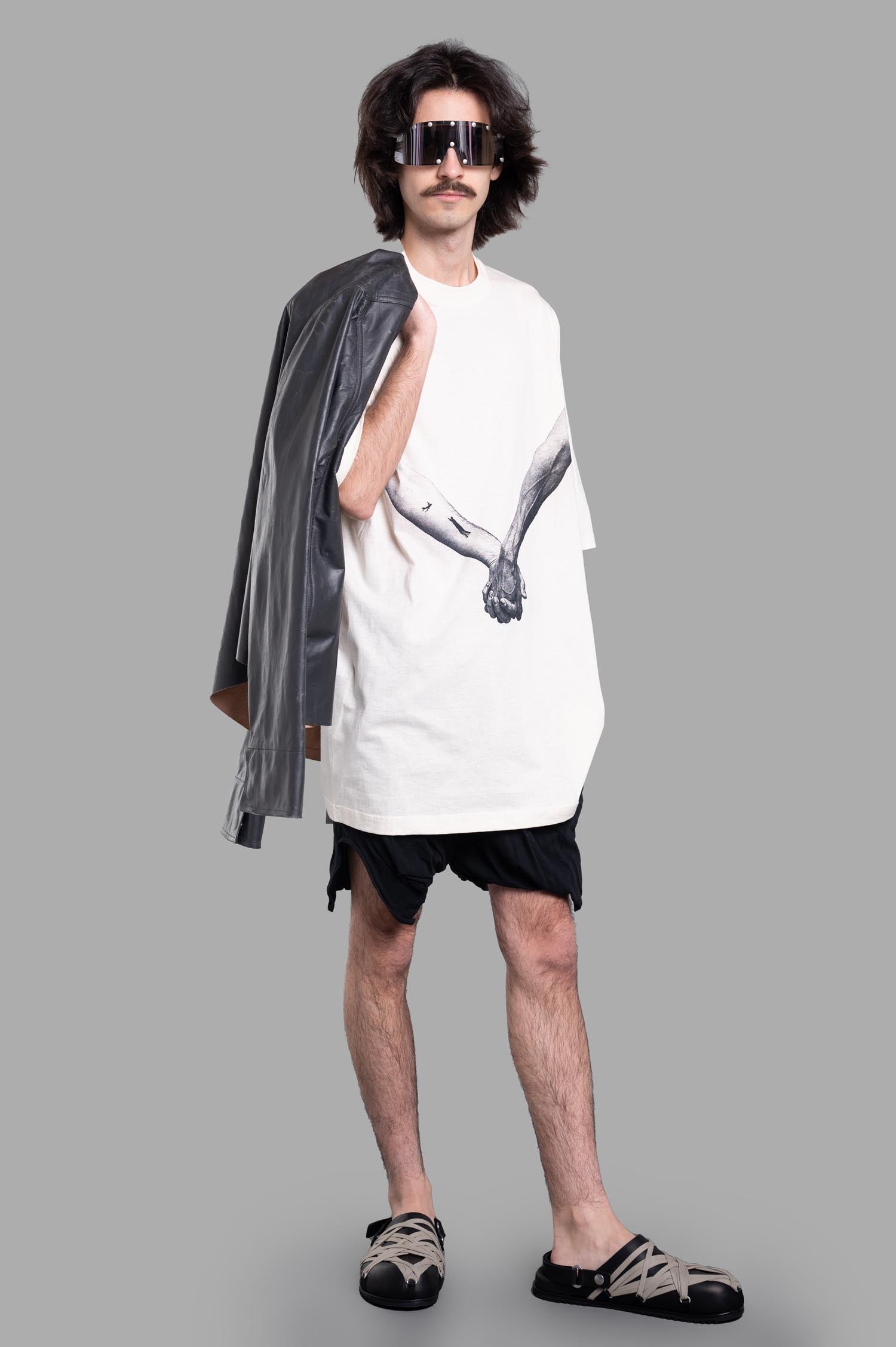 Rick Owens Jumbo T-shirt in ecru on model; front view with bold graphic print, paired with black shorts and sandals.