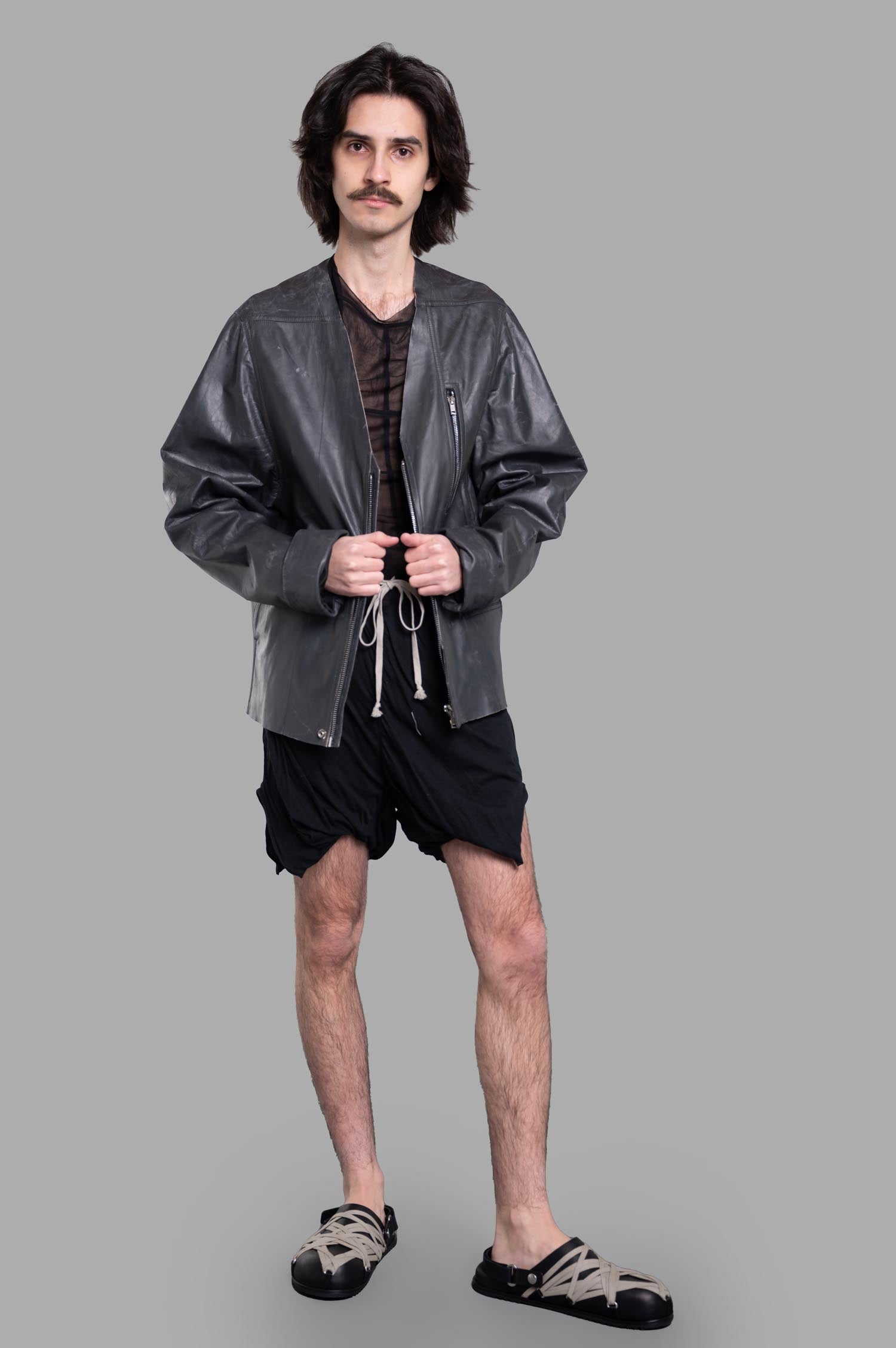 Rick Owens Hollywood V-safety Jacket in black leather, front view. Features V-neck, boxy fit, and large zip breast pocket.