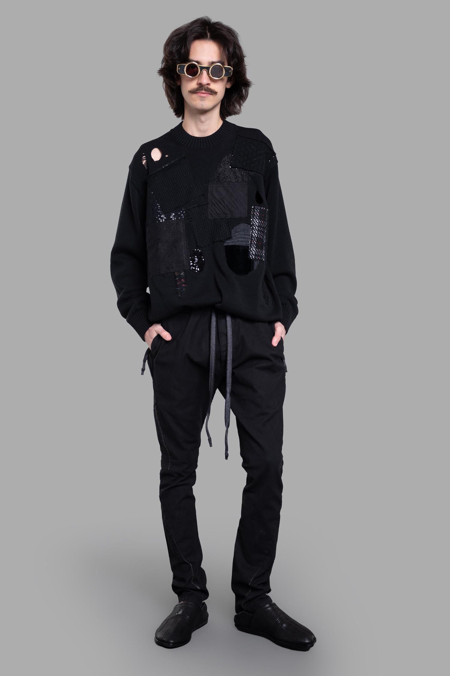 Junya Watanabe Patchwork Sweater in black, front view on model, featuring crew neck and long sleeves, cotton fabric.